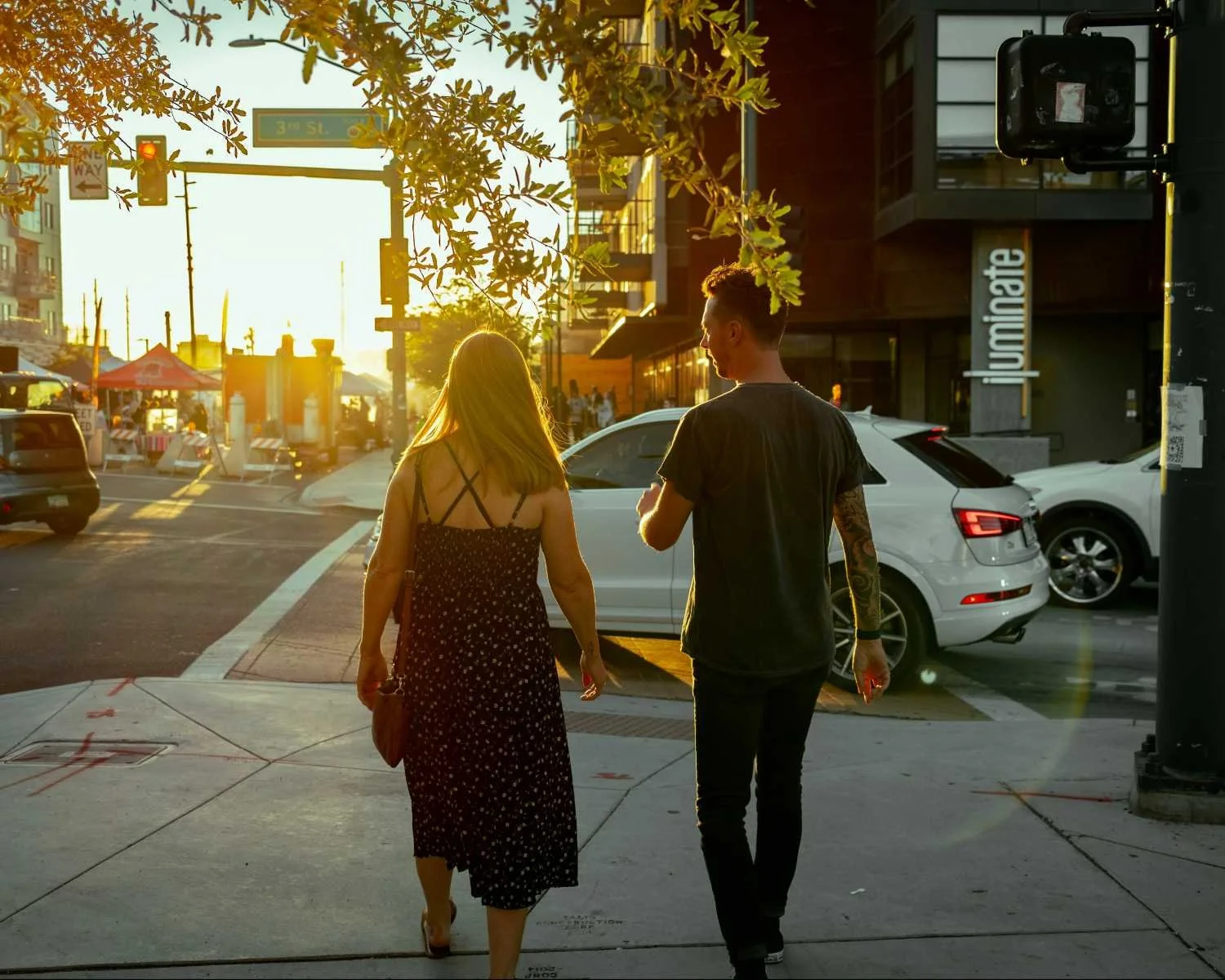 Man and woman walking side by side on an urban sidewalk at sunset, illustrating secure attachment in dating therapy for men.