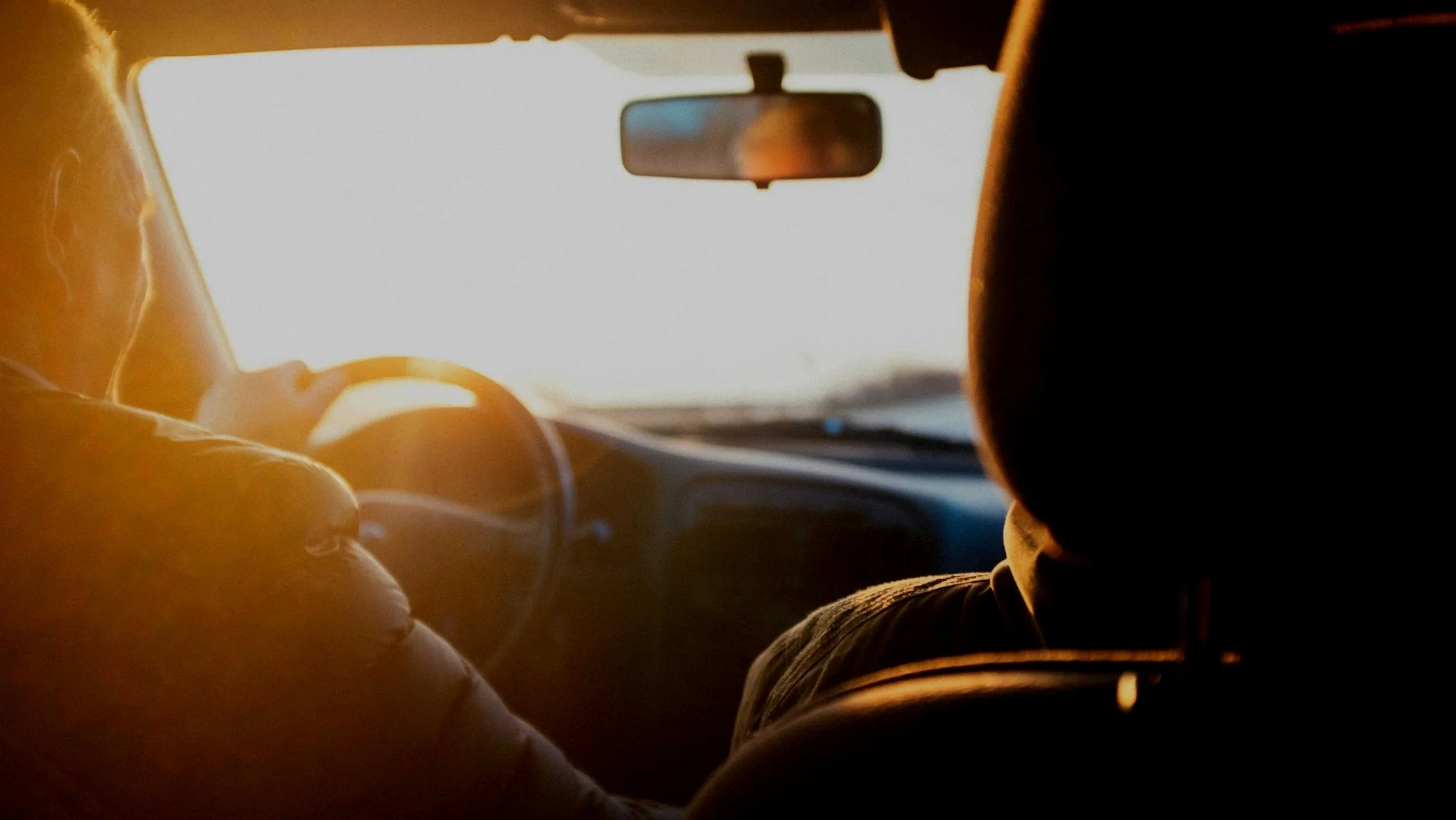 Two people sitting in silence in a car, representing toxic relationship therapy for men in Mooresville, NC.