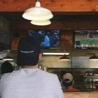 Man watching a baseball game at a bar, representing the everyday moments where connection either shows up or doesn't.