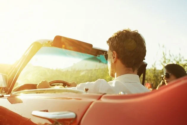 Man and woman in a convertible car on a sunny day, representing men's anxiety counseling and living on your own terms in Mooresville, NC.