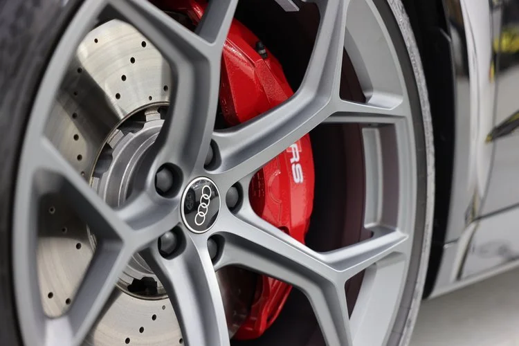 Audi car wheel with red brake caliper