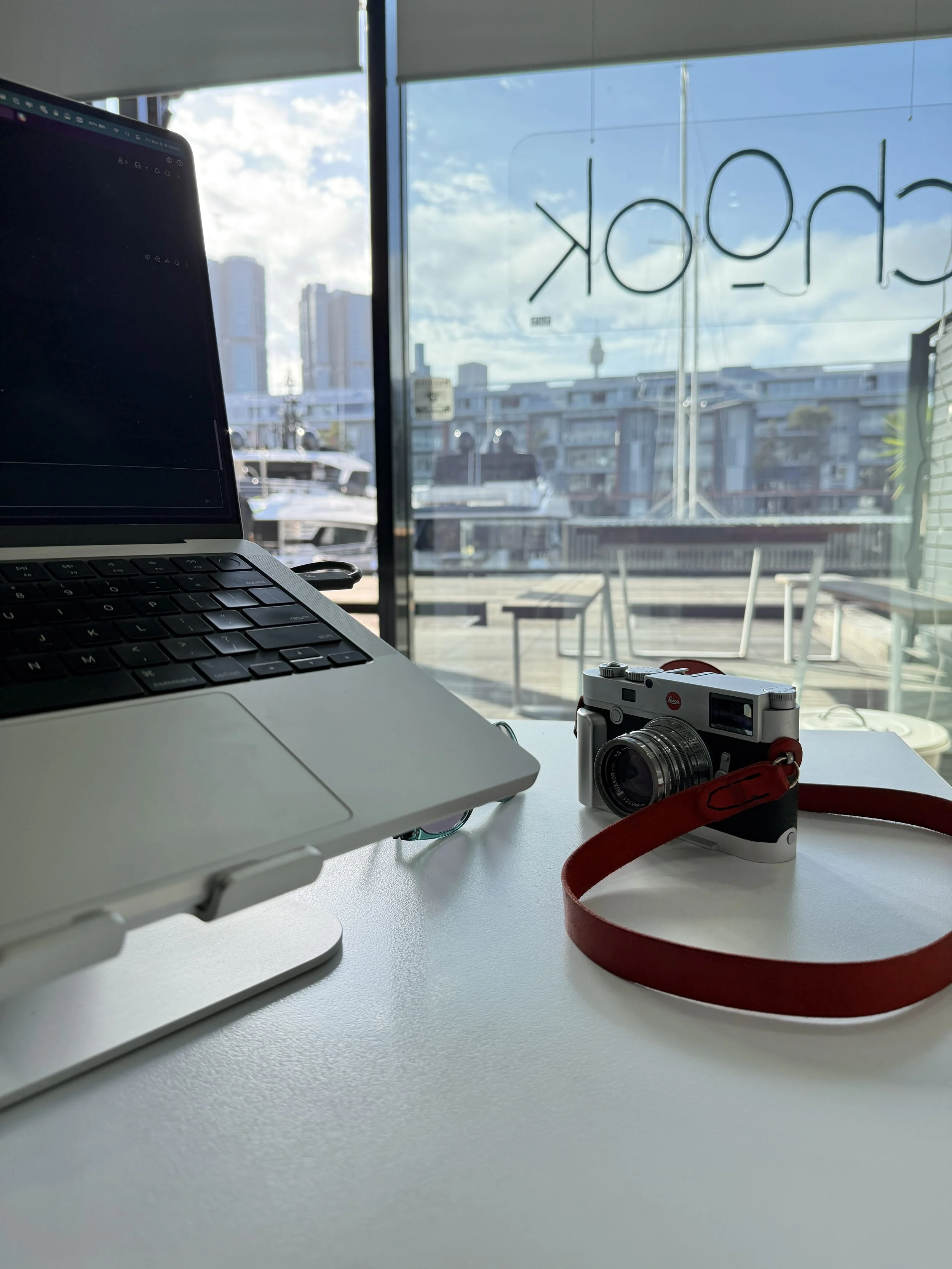 Camera sitting on a table looking out at the Sydney skyline