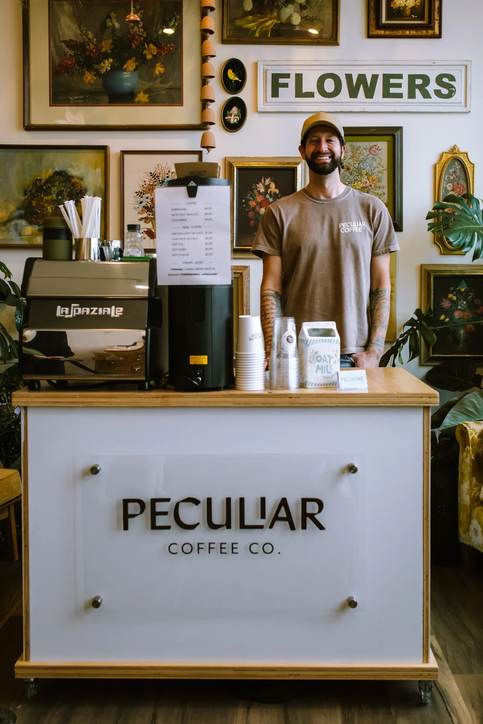 Smiling barista standing behind a coffee cart