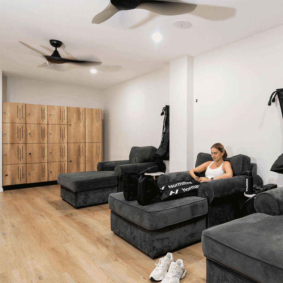 Compression therapy session with Normatec boots in the recovery lounge at Inertia Fitness West End Brisbane