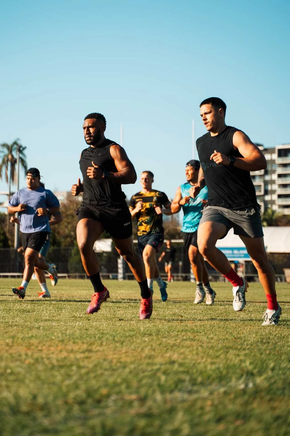 Athletes sprinting during outdoor speed and conditioning training with Inertia Academy West End Brisbane
