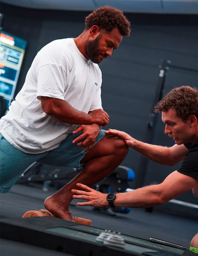 Physiotherapist guiding a client through a strength and mobility assessment at Inertia Fitness West End Brisbane