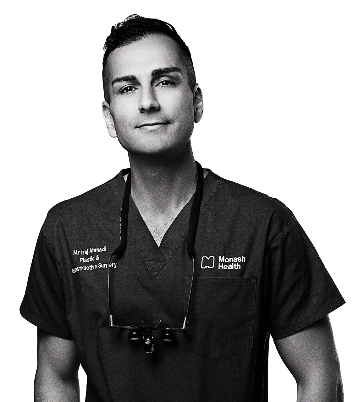 Black and white photo of a male healthcare professional wearing scrubs with the Monash Health logo, a name tag reading Mr. Iraj Ahmadi Plastic & Reconstructive Surgery, and a stethoscope around his neck.