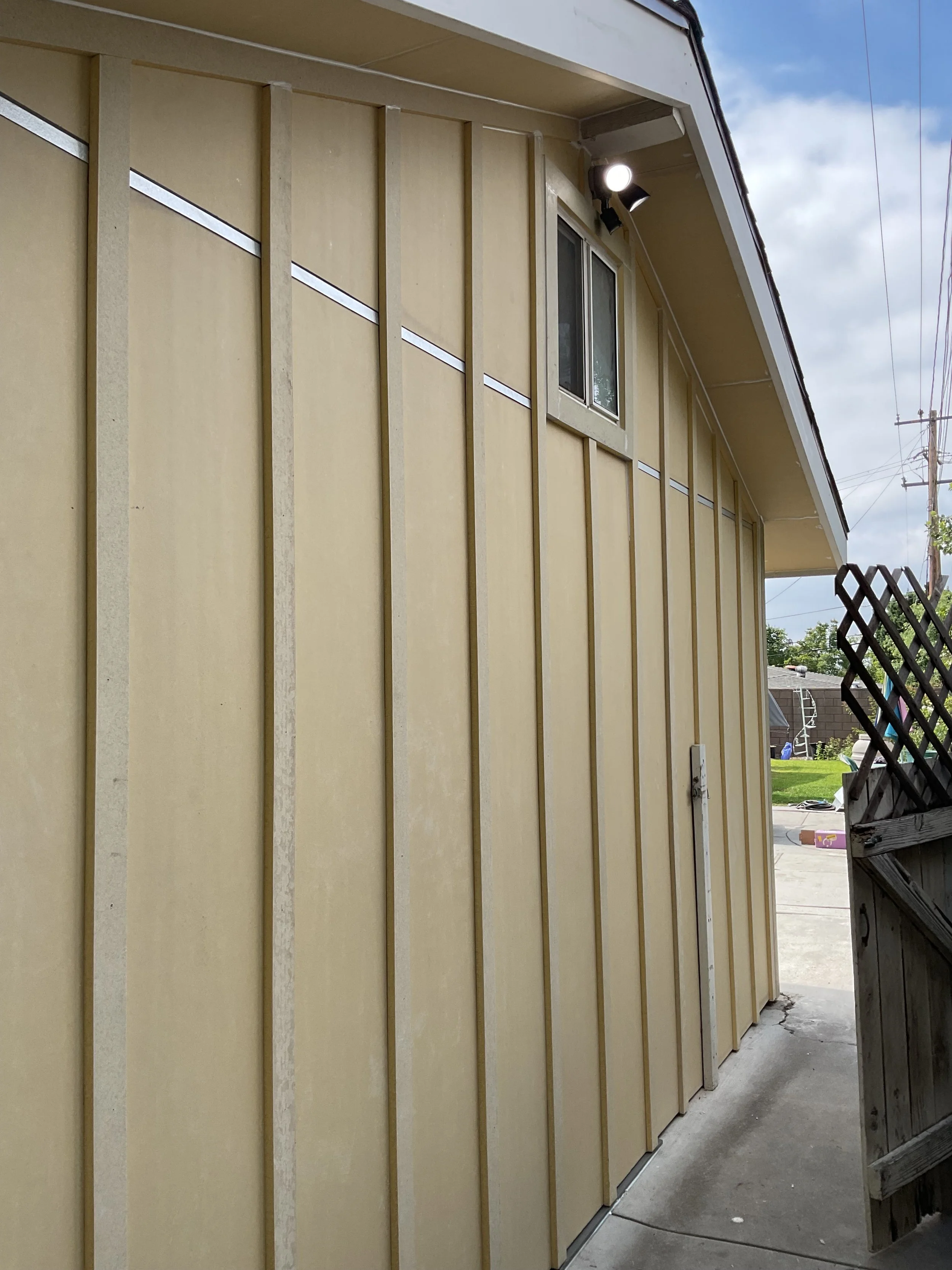 Installed vertical board & batten style James Hardie siding.