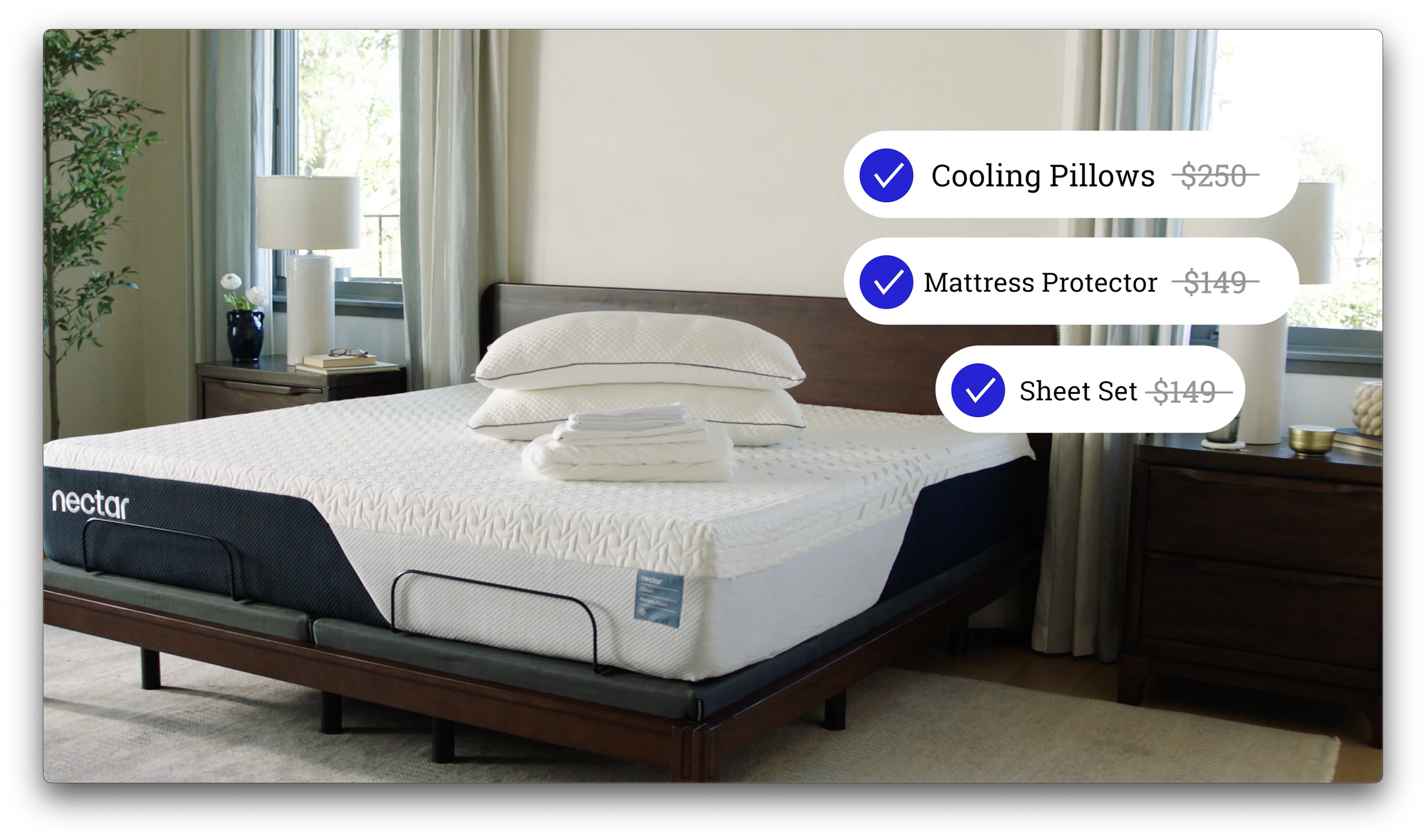 A bedroom with a bed that has an Nectar mattress, neatly arranged pillows, and a bed sheet set. There are nightstands on each side of the bed with lamps and decorative items. Large windows with curtains allow natural light into the room.