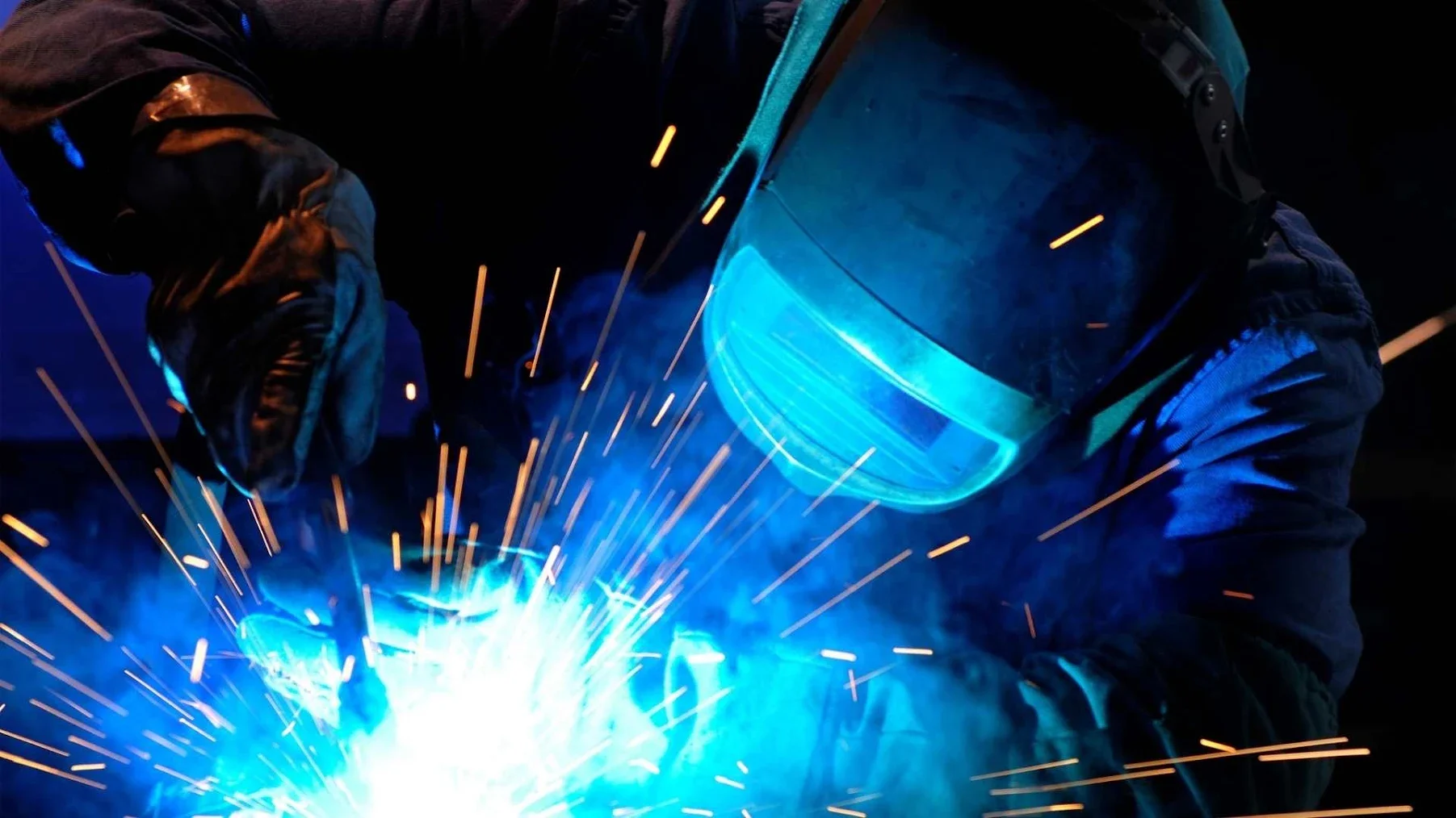 A welder working in an industrial environment.
