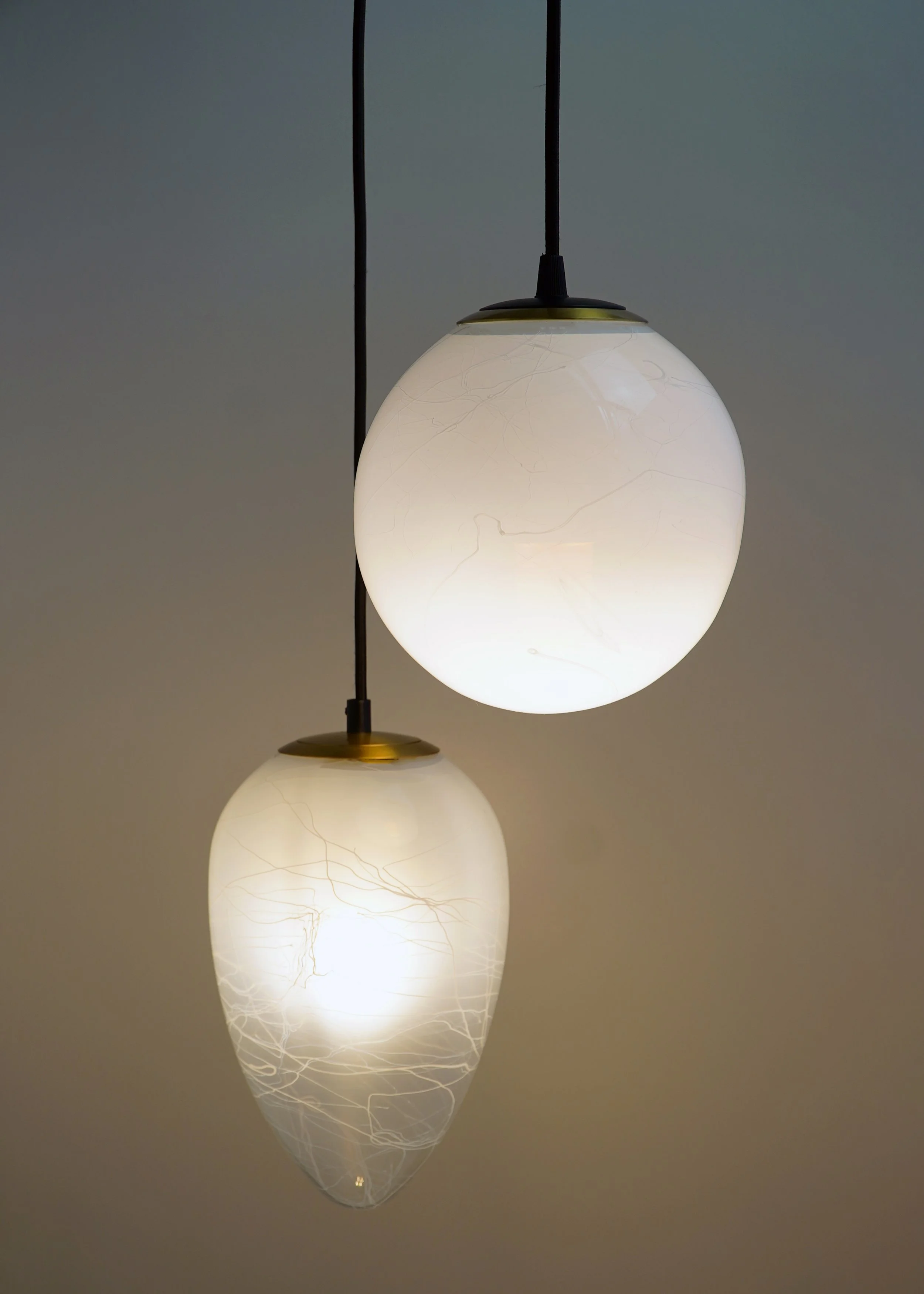 Silta captures the fine, natural lines of silt and stone. Hand-formed, each light tells a quiet story through its striated surface.