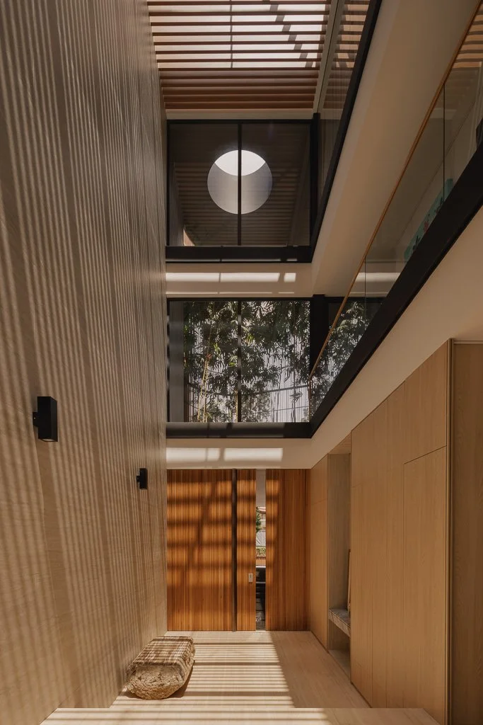triple volume entrance way of a home with a bamboo garden on the second floor