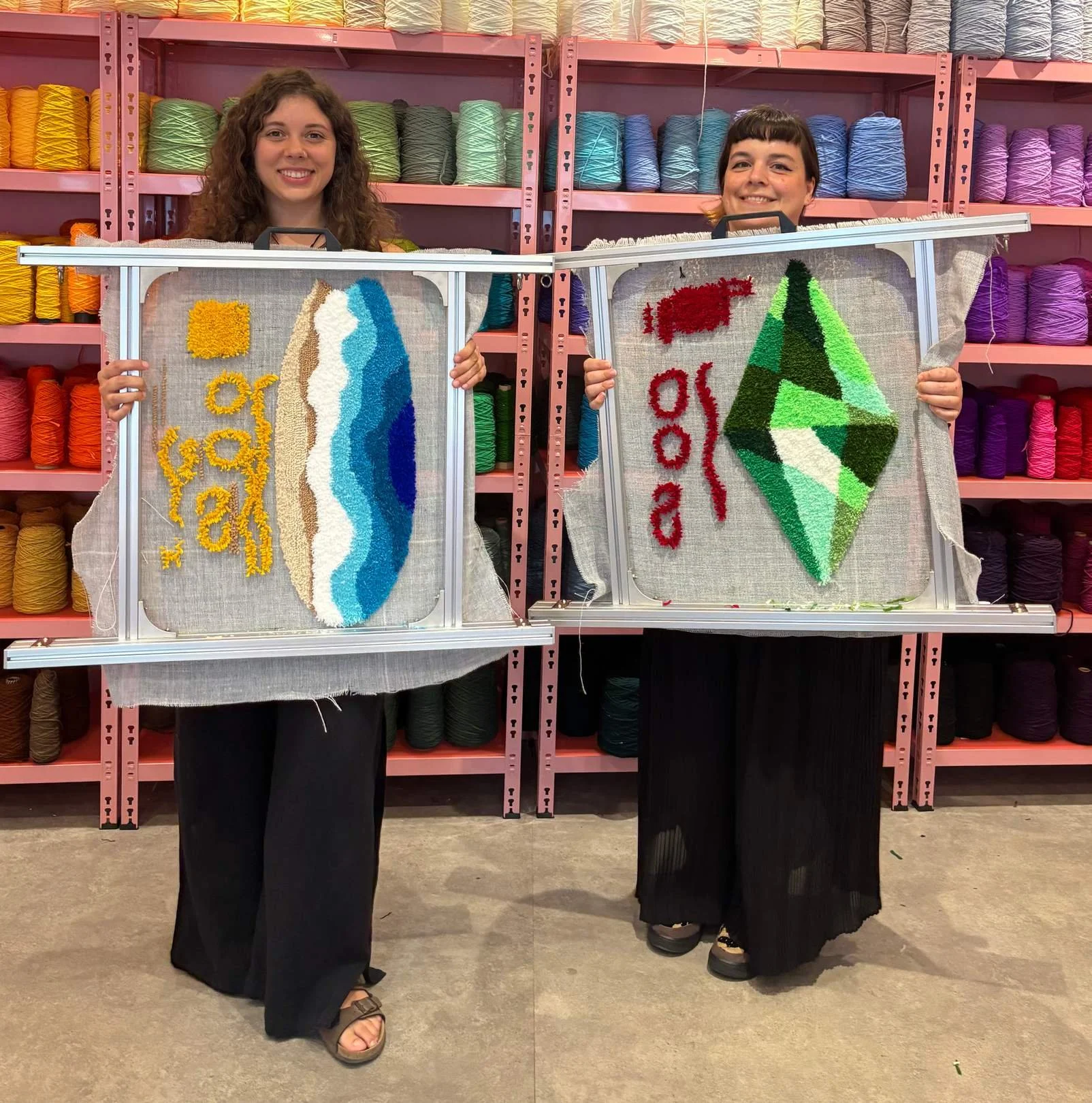 Two people hold their tufted rugs. (The OG)