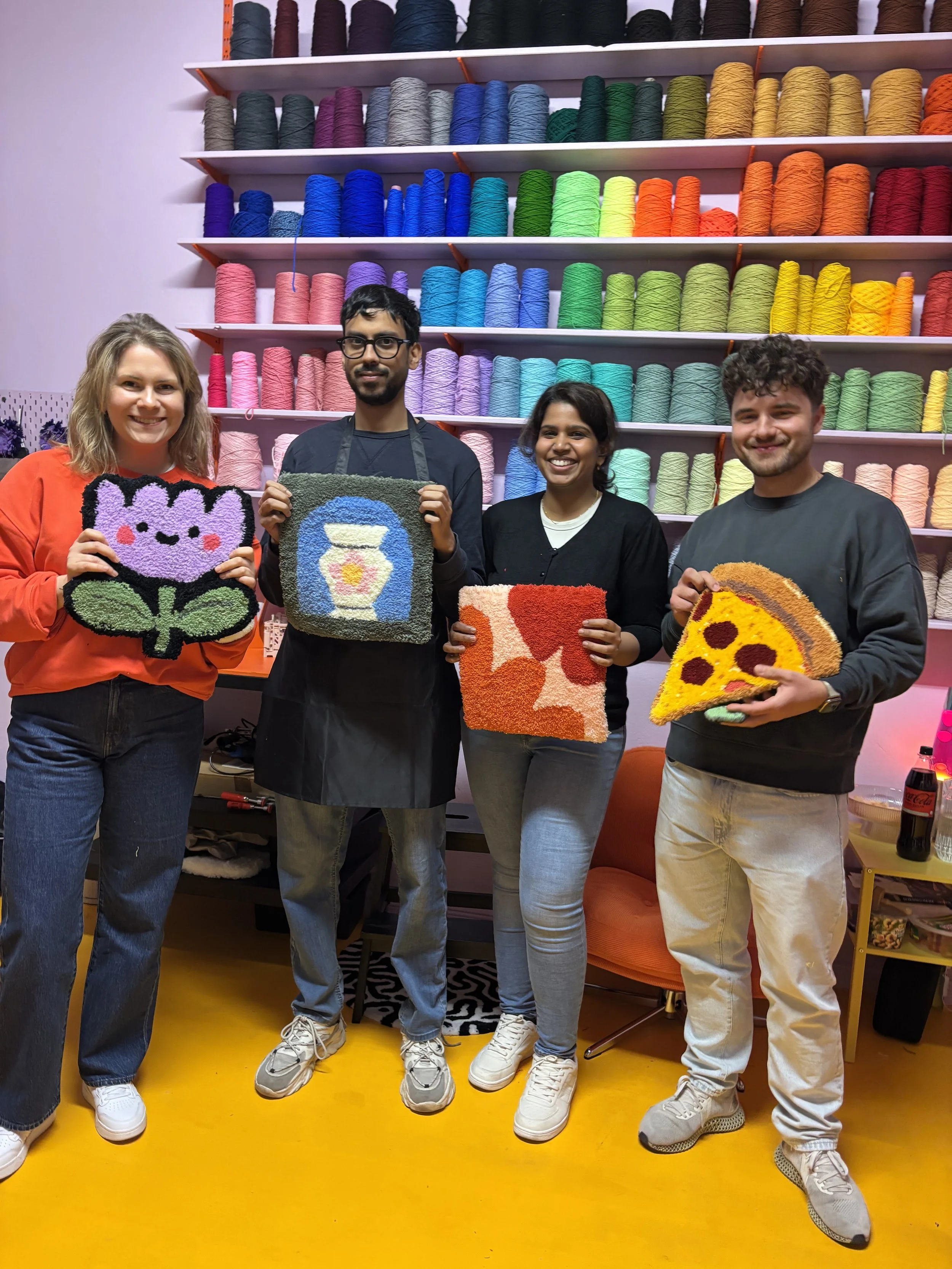 Group of colleagues hold their tufted rugs from Tuft Tuft Berlin