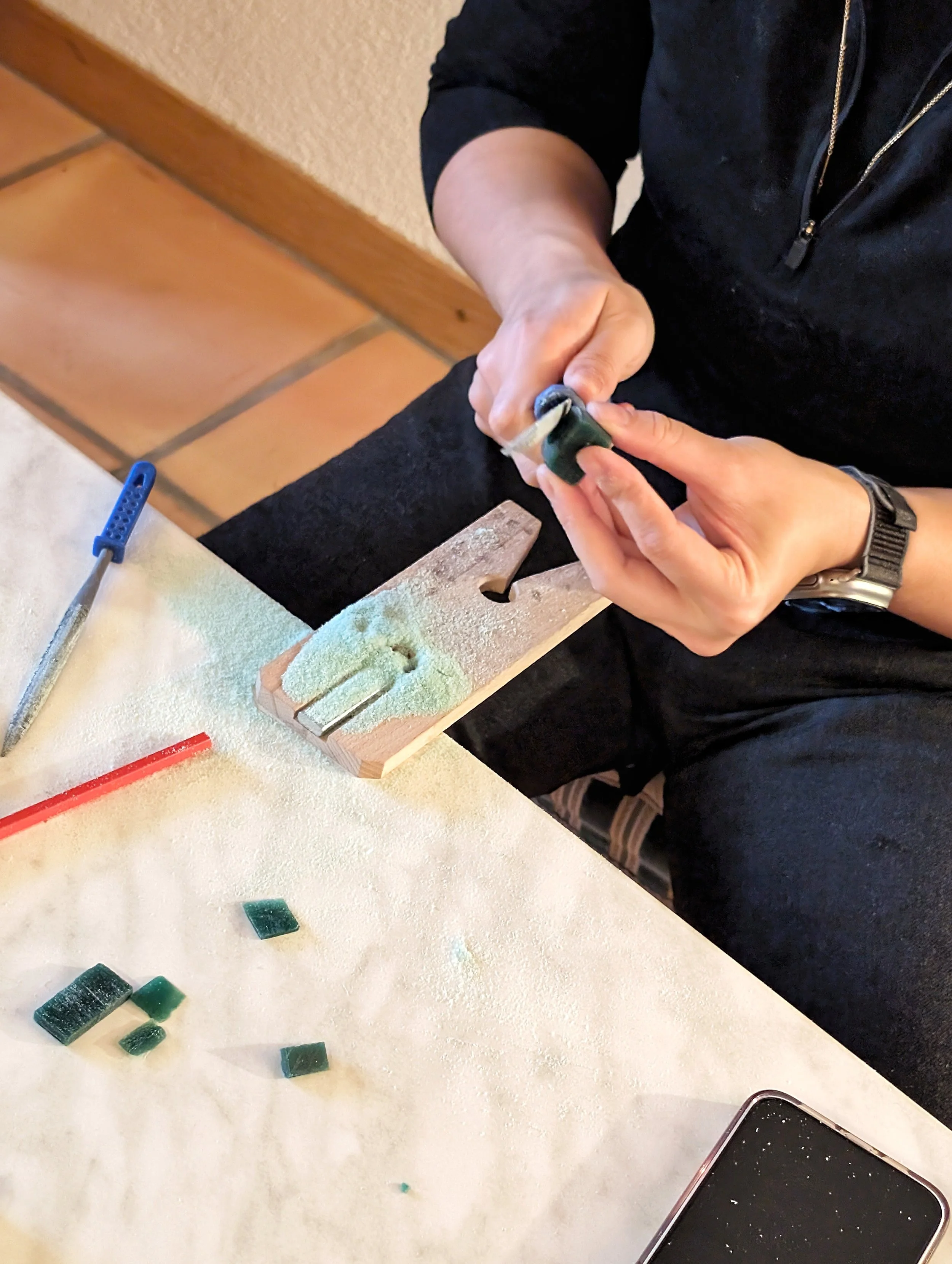A jeweller's saw is used to carve the wax mould