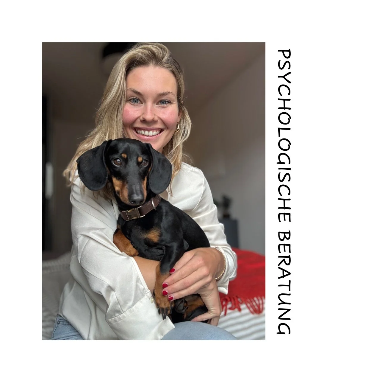 A smiling woman holding a black and tan dachshund in her arms inside a home.