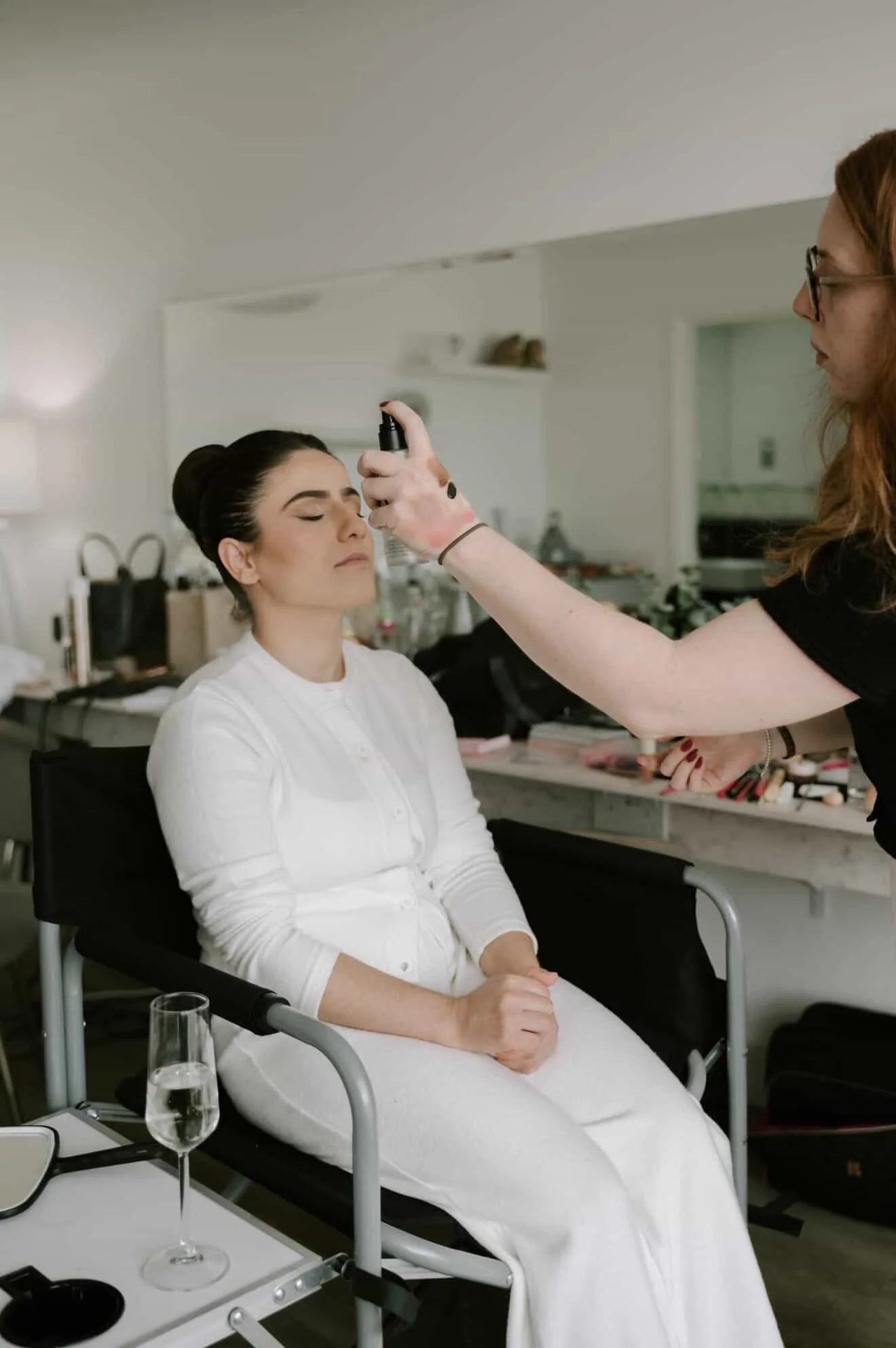 Wedding morning makeup preparation with luxury bridal skincare and makeup application.