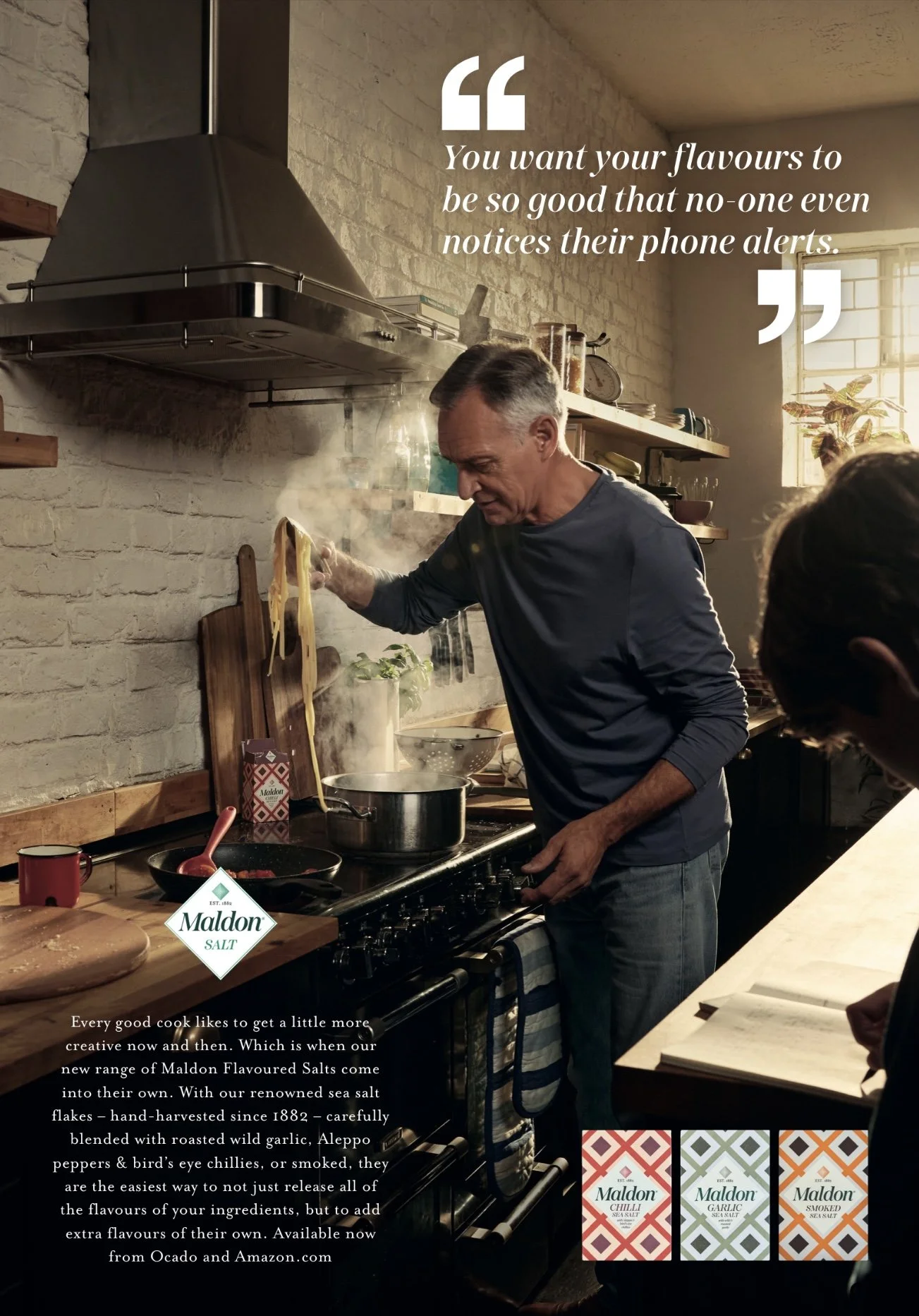 Man cooking in kitchen using Maldon Salt with pasta, stove, and cookware; advertisement tagline visible.