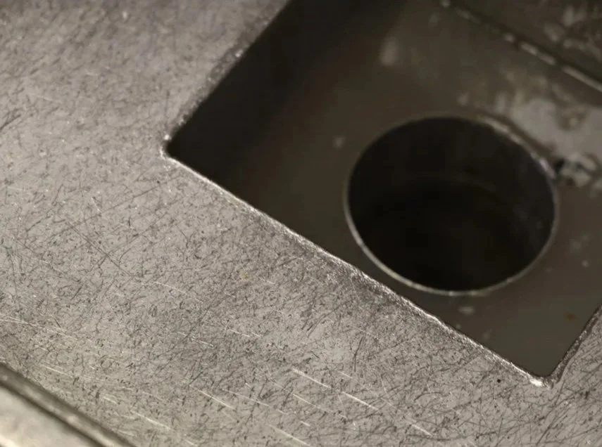 Close-up of a metal surface with a round hole or opening