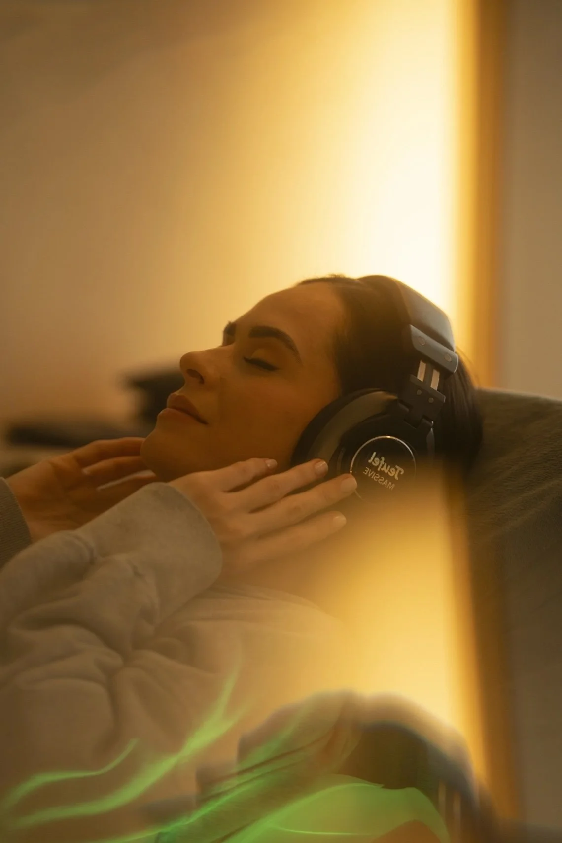 Close-up of a water droplet splash captured mid-air above a dark green surface