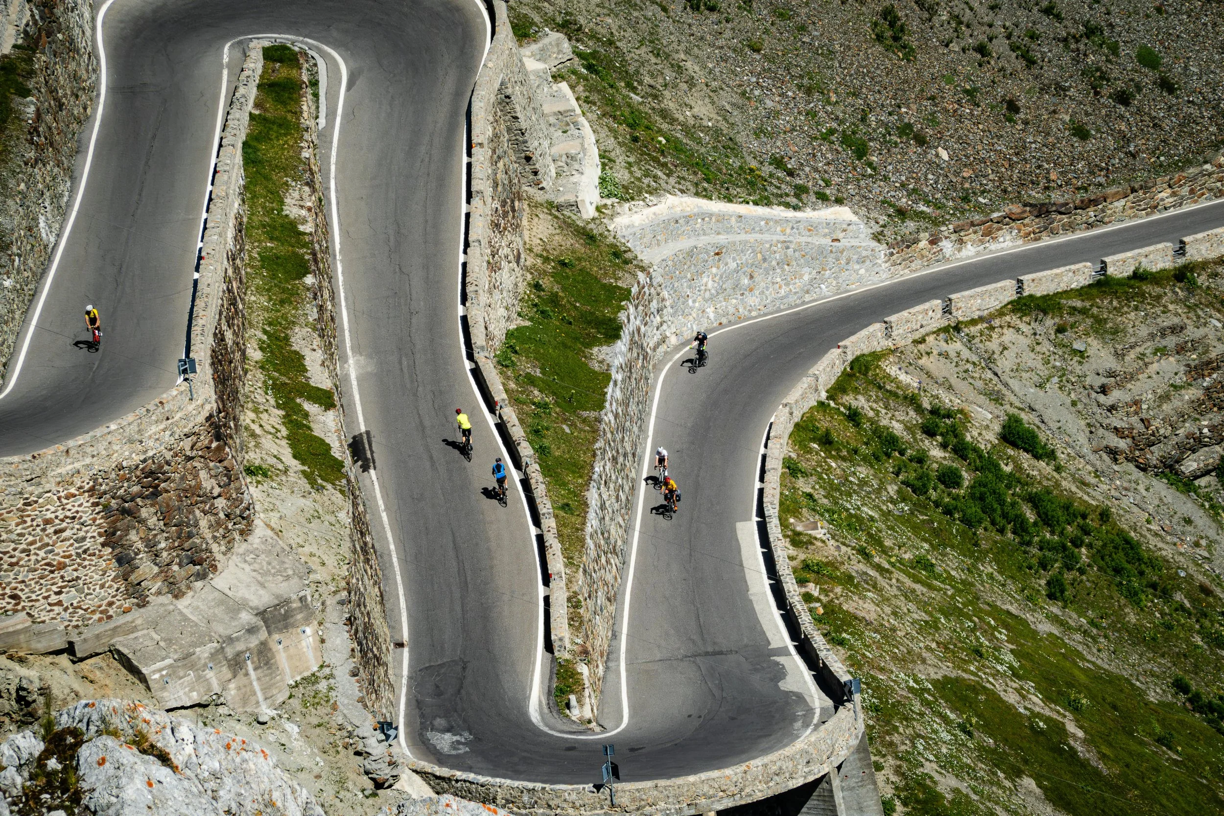 Cyclists on switchbacks up a mountain