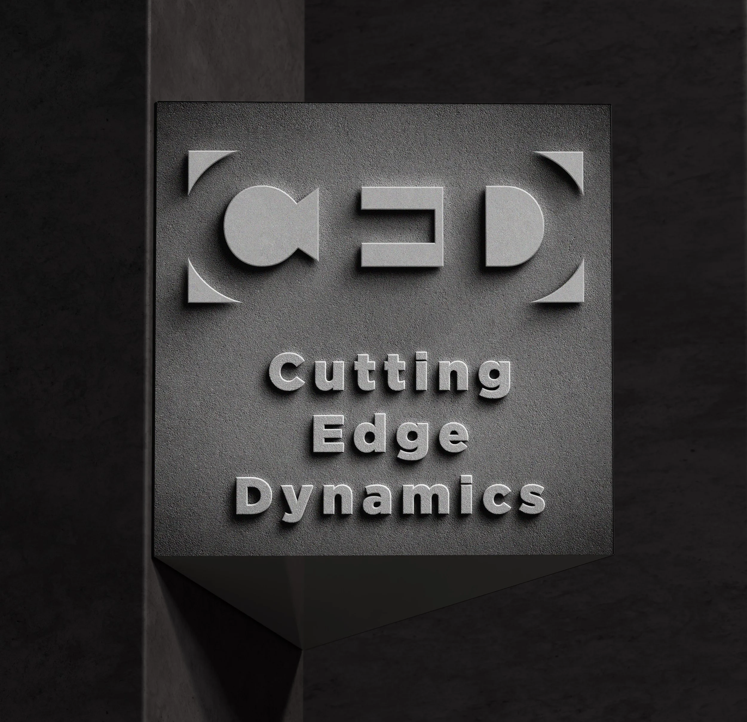 3D wall sign with logo and text reading 'Cutting Edge Dynamics' on gray background.