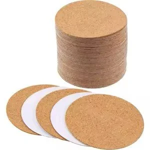 A stack of cylindrical cork coasters with four additional coasters laid flat in front.