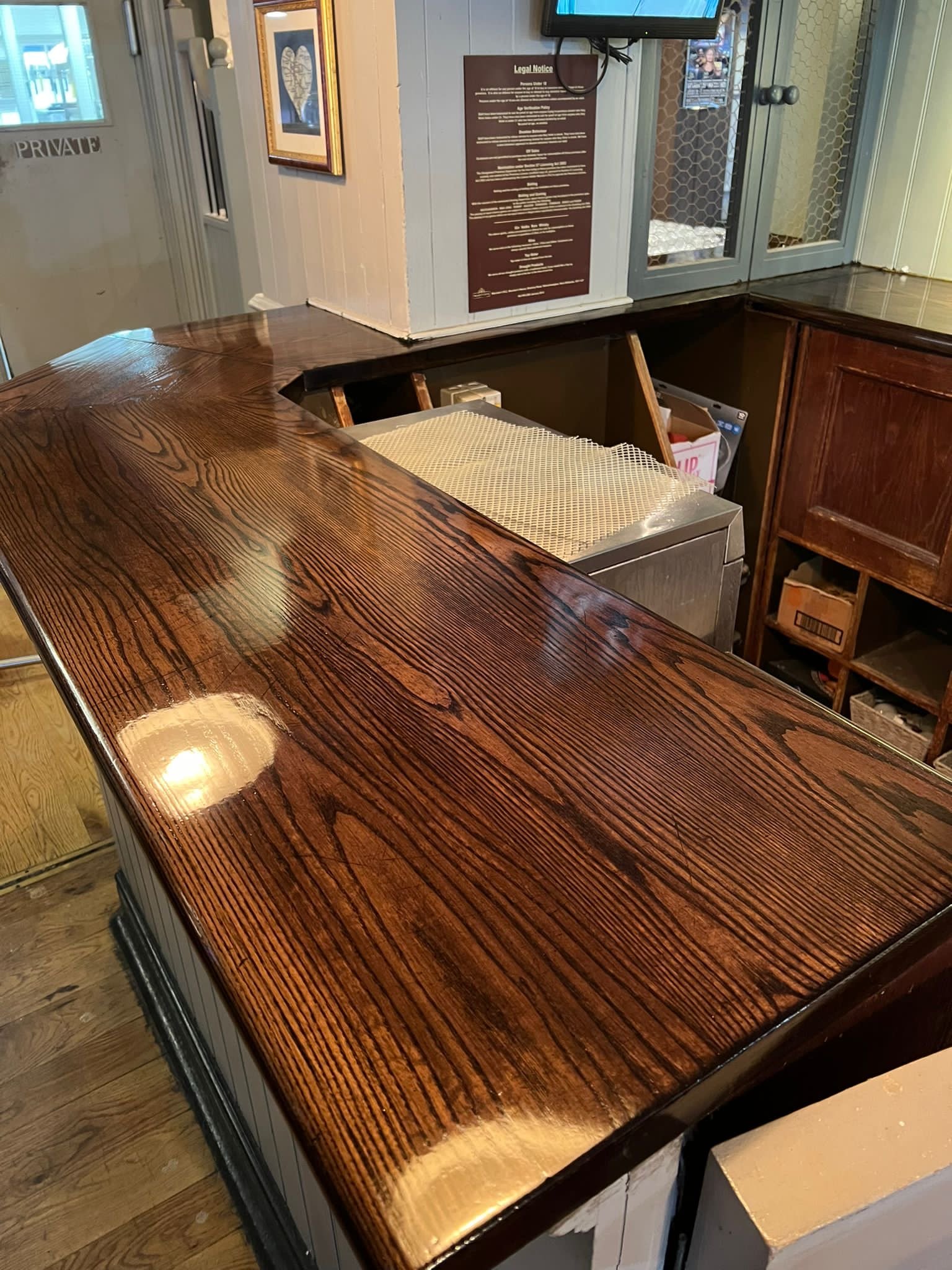 Close-up of a polished wooden counter in a restaurant or café.