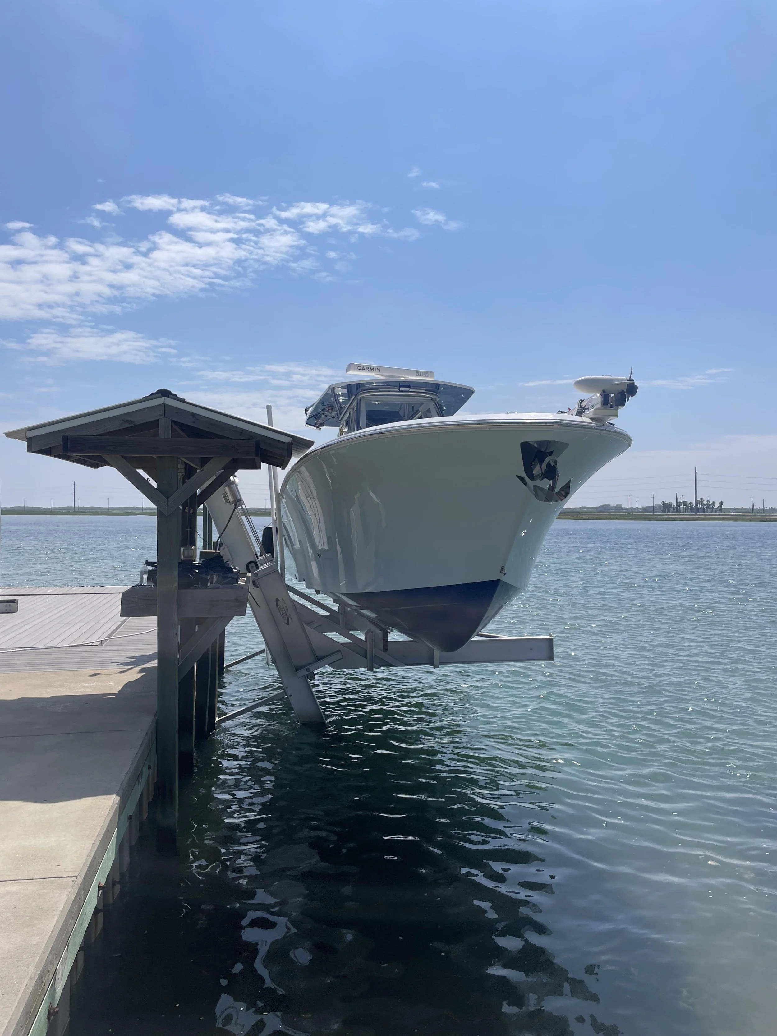 High-performance boat lift system supporting a large vessel, engineered by JKT Marine to ensure peak performance and structural integrity in South Florida.