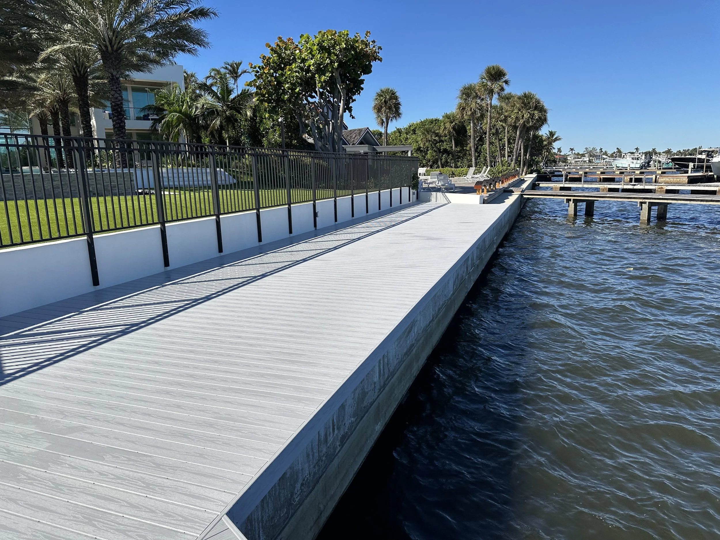Premium concrete seawall and waterfront dock project completed for a luxury canal front home is West Palme Beach by JKT Marine.