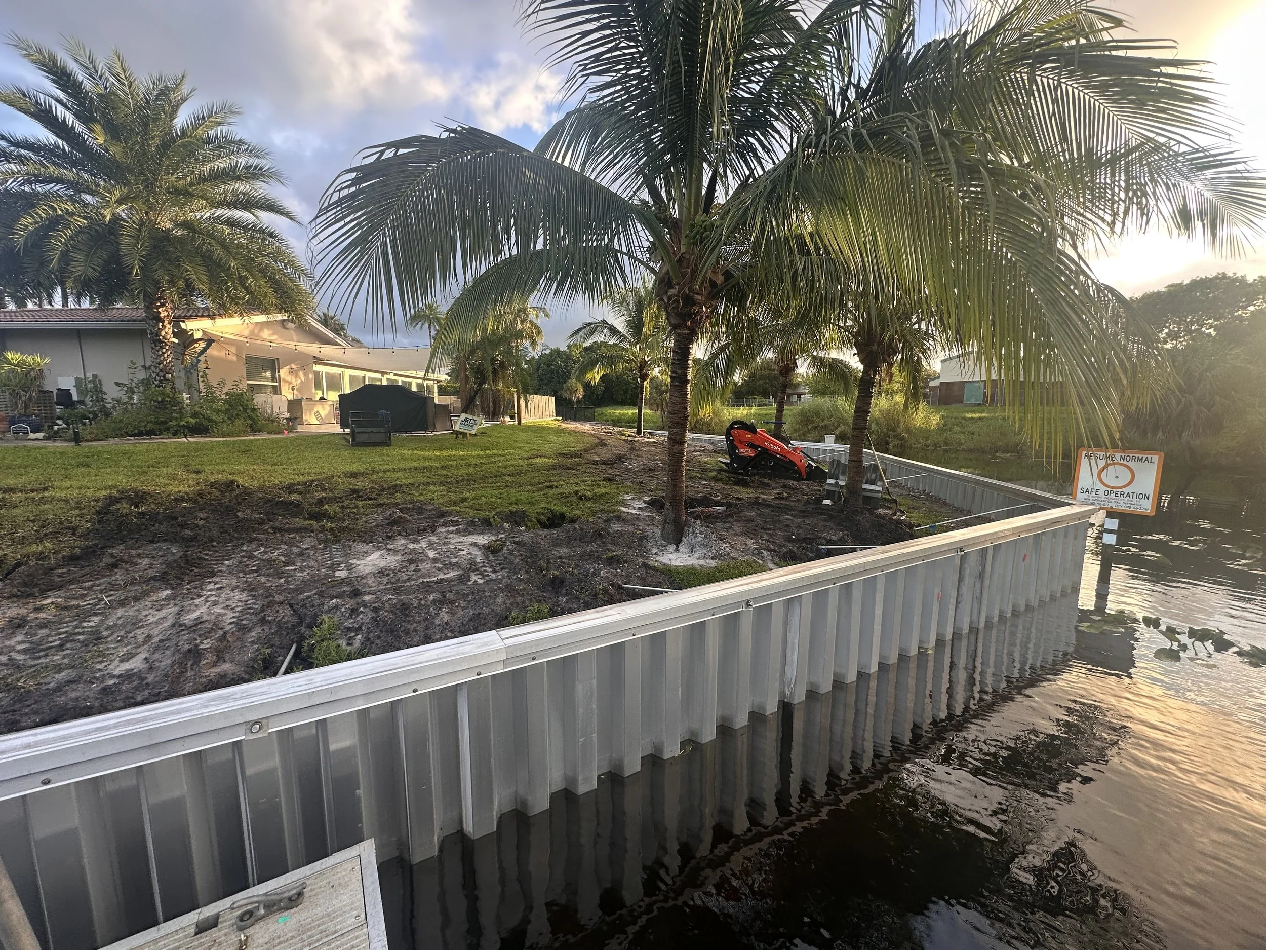 New aluminum  seawall replacement project by JKT Marine in Lake Worth, Florida. Professional seawall contractor specializing in waterfront erosion protection and marine construction.