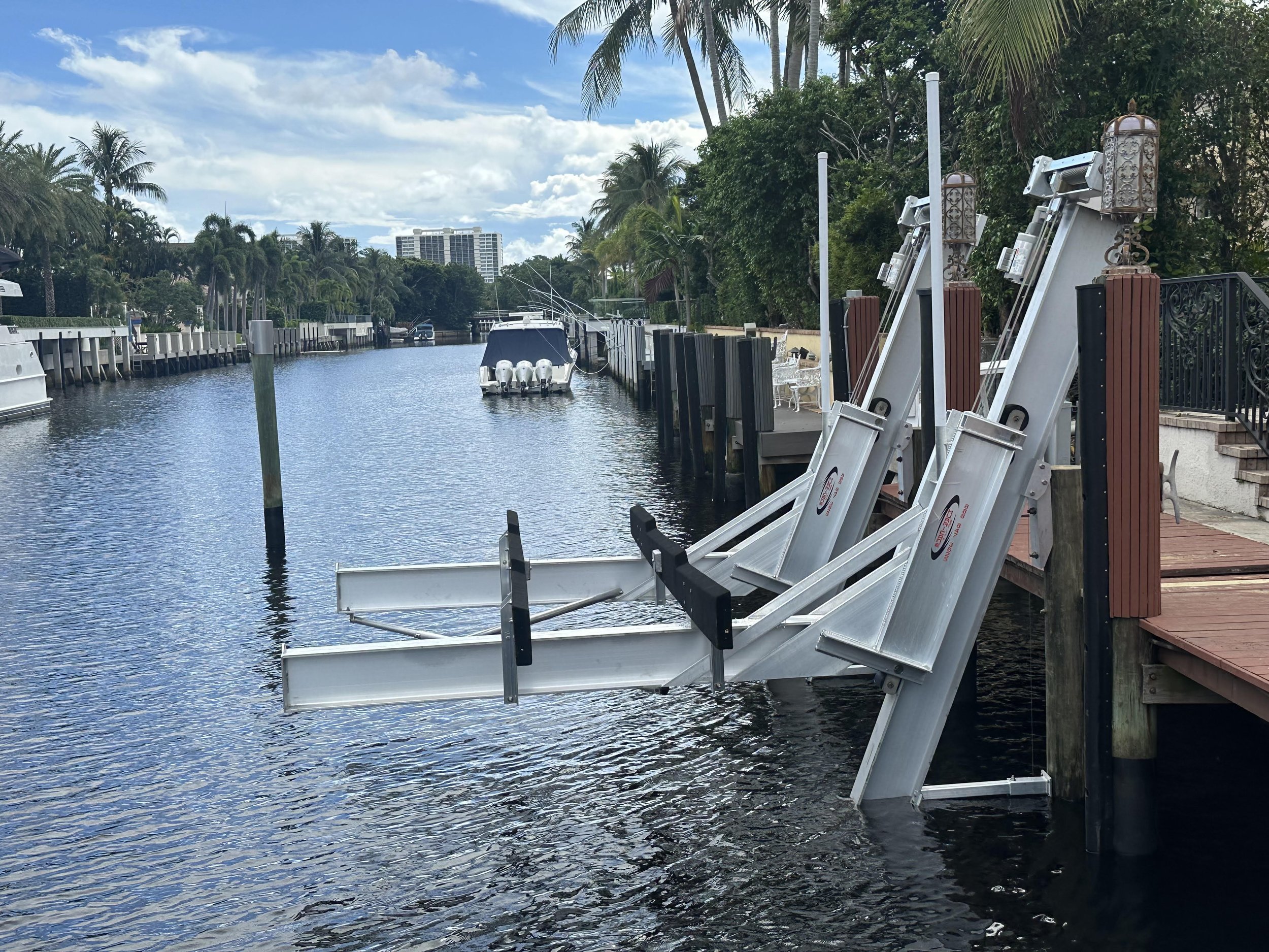 Precision-engineered dual-arm boat lift installation on a residential canal, showcasing expert marine infrastructure designed for reliable vessel protection and long-term durability.