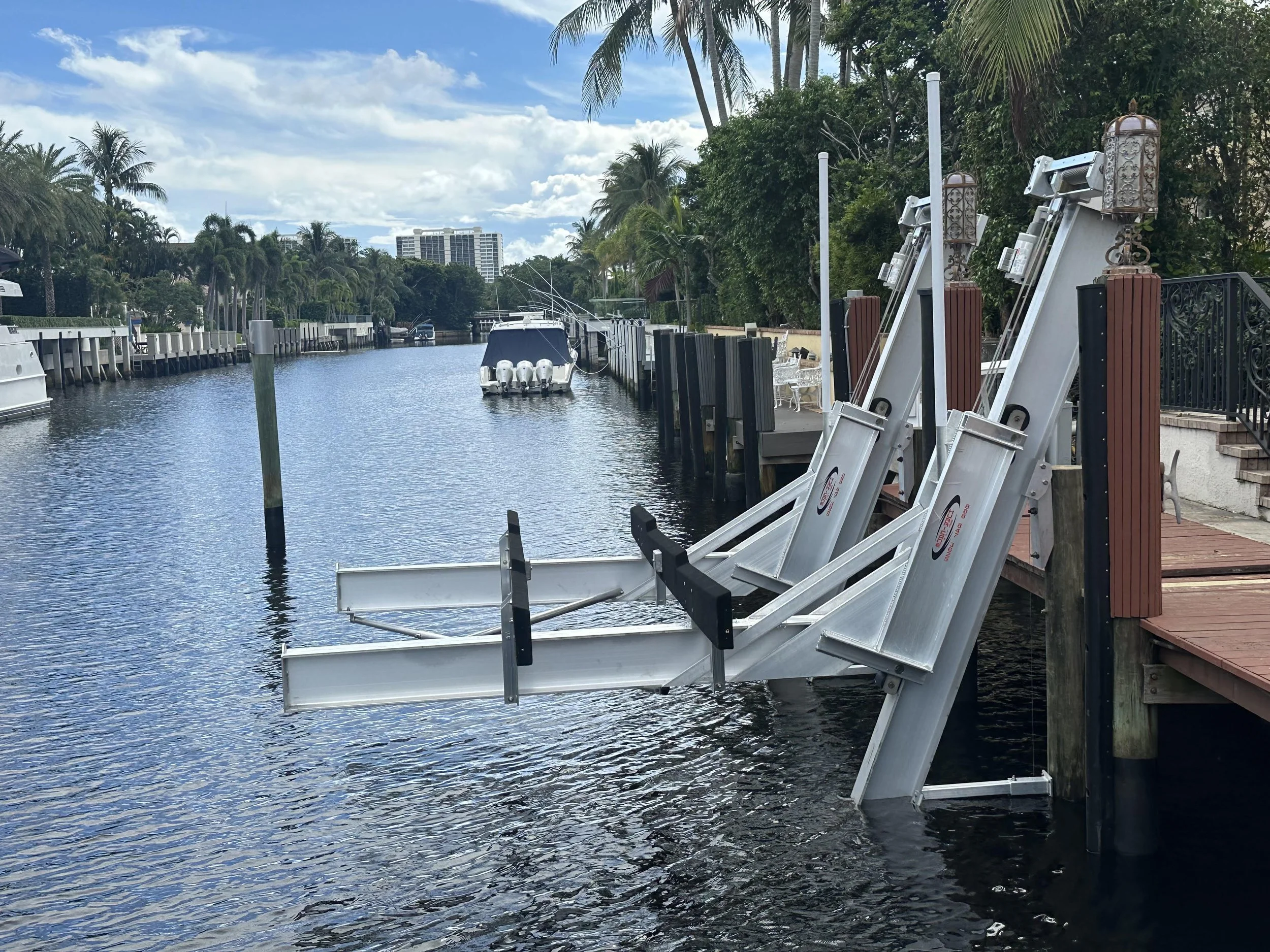 Precision-engineered dual-arm boat lift installation on a residential canal, showcasing expert marine infrastructure designed for reliable vessel protection and long-term durability.