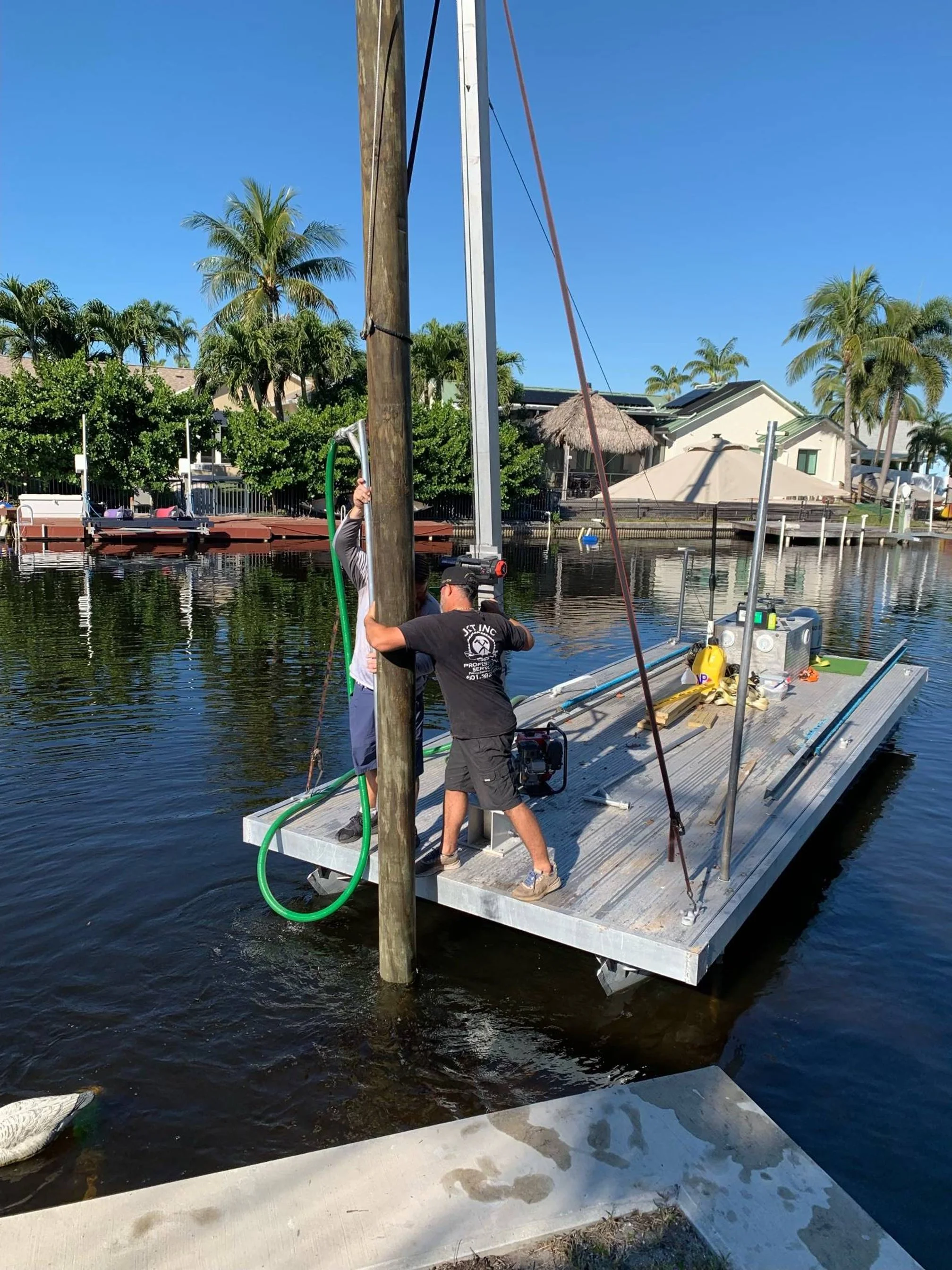 Precision piling installation by marine specialists using advanced hydraulic techniques to establish the essential structural bedrock for a high-performance residential dock system.