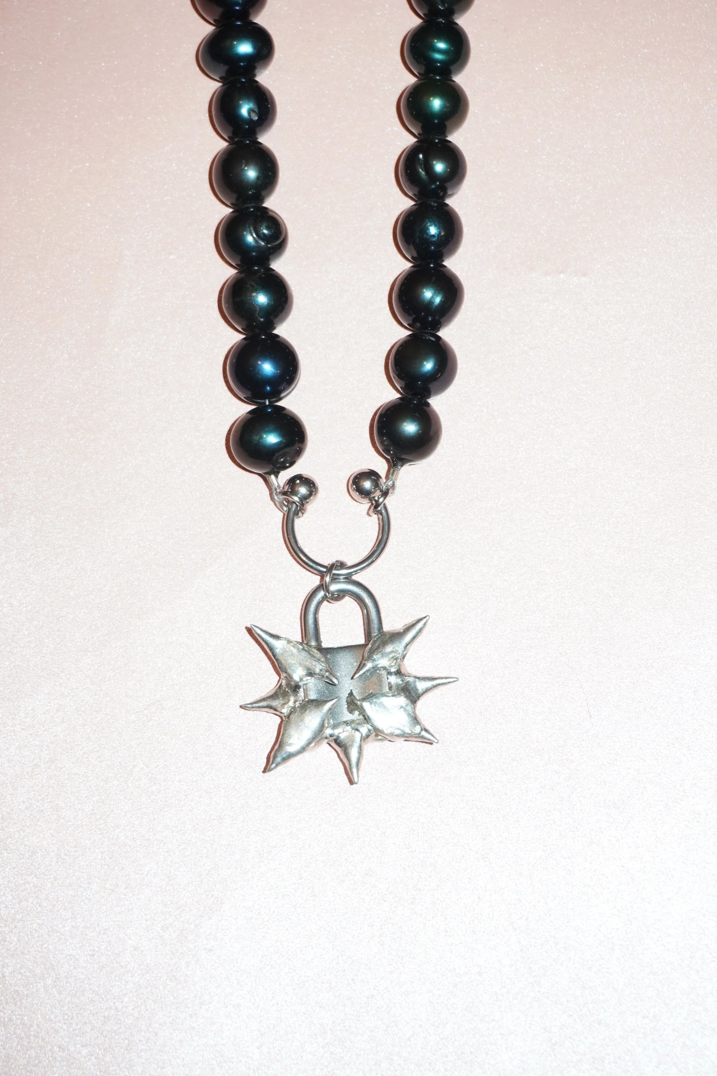My Dearest World black pearl necklace with pierced spiky lock