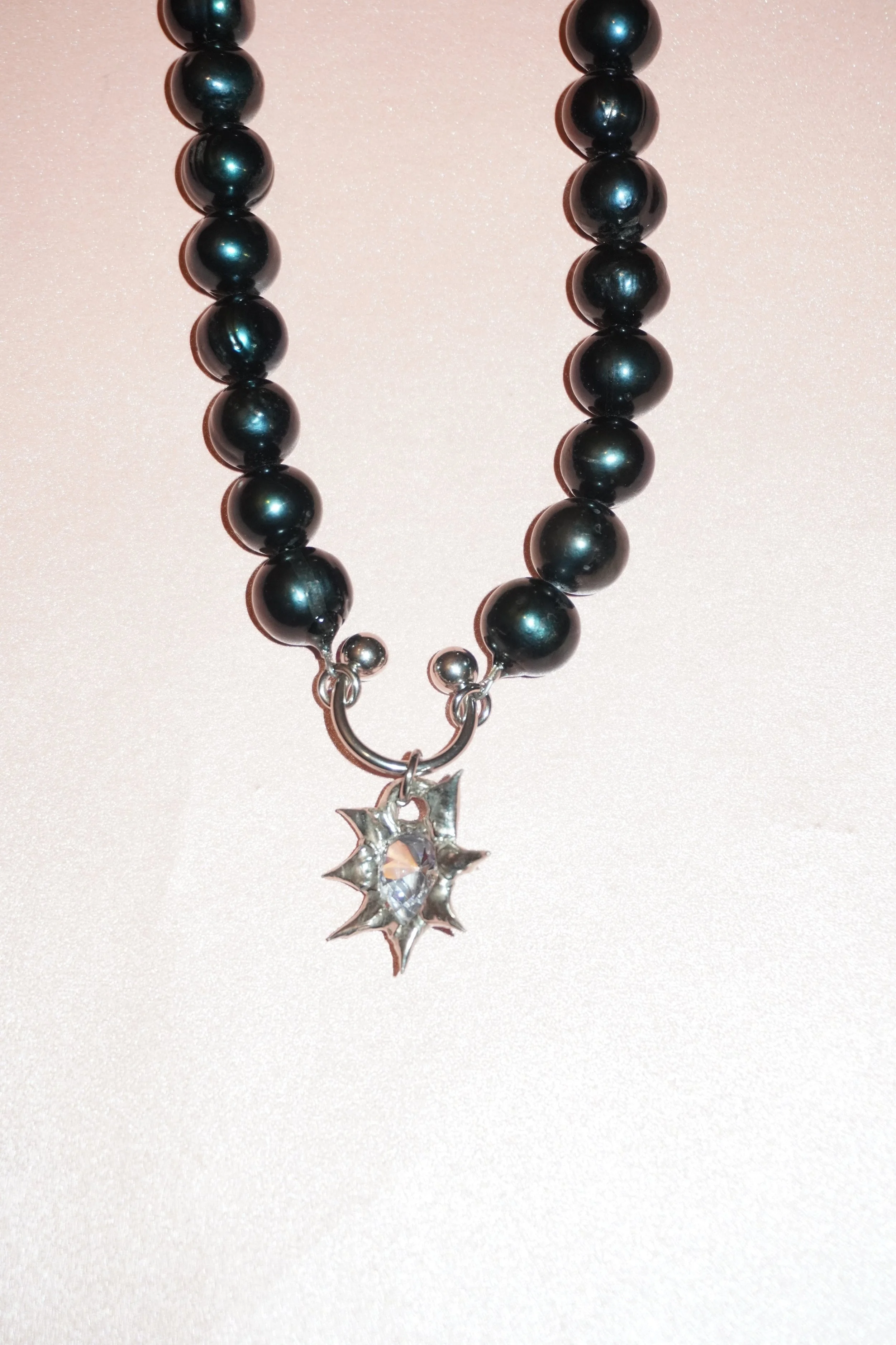 My Dearest World black pearl necklace with pierced spiky teardrop gem