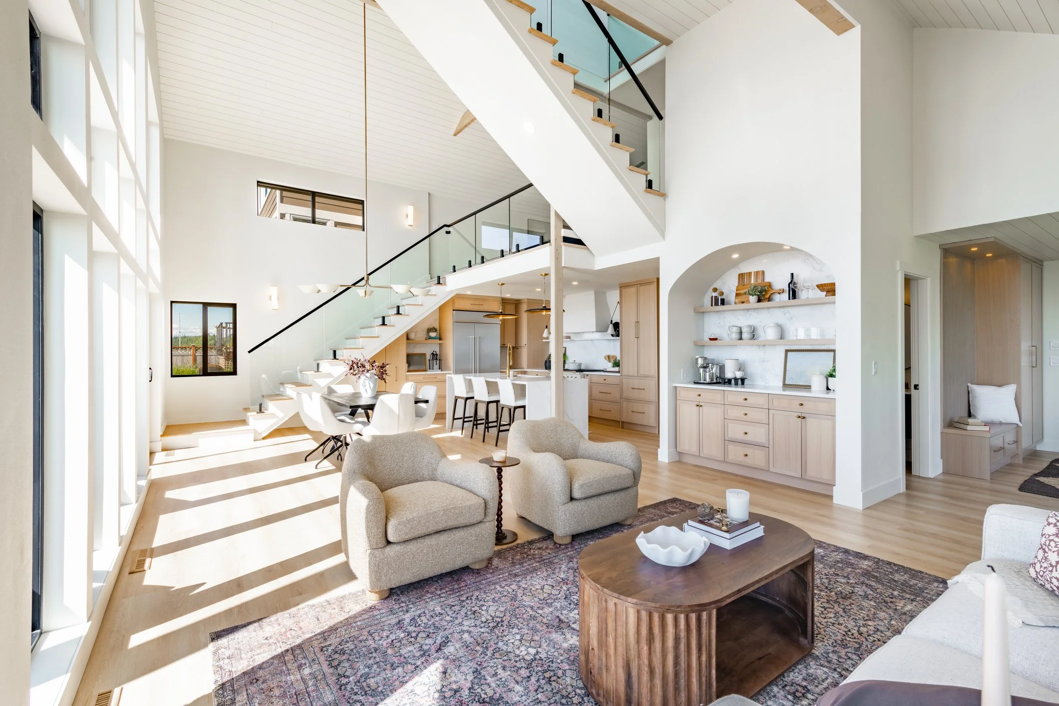 New Kitchen with white cabinets, new appliances, and an island with a sink in it.