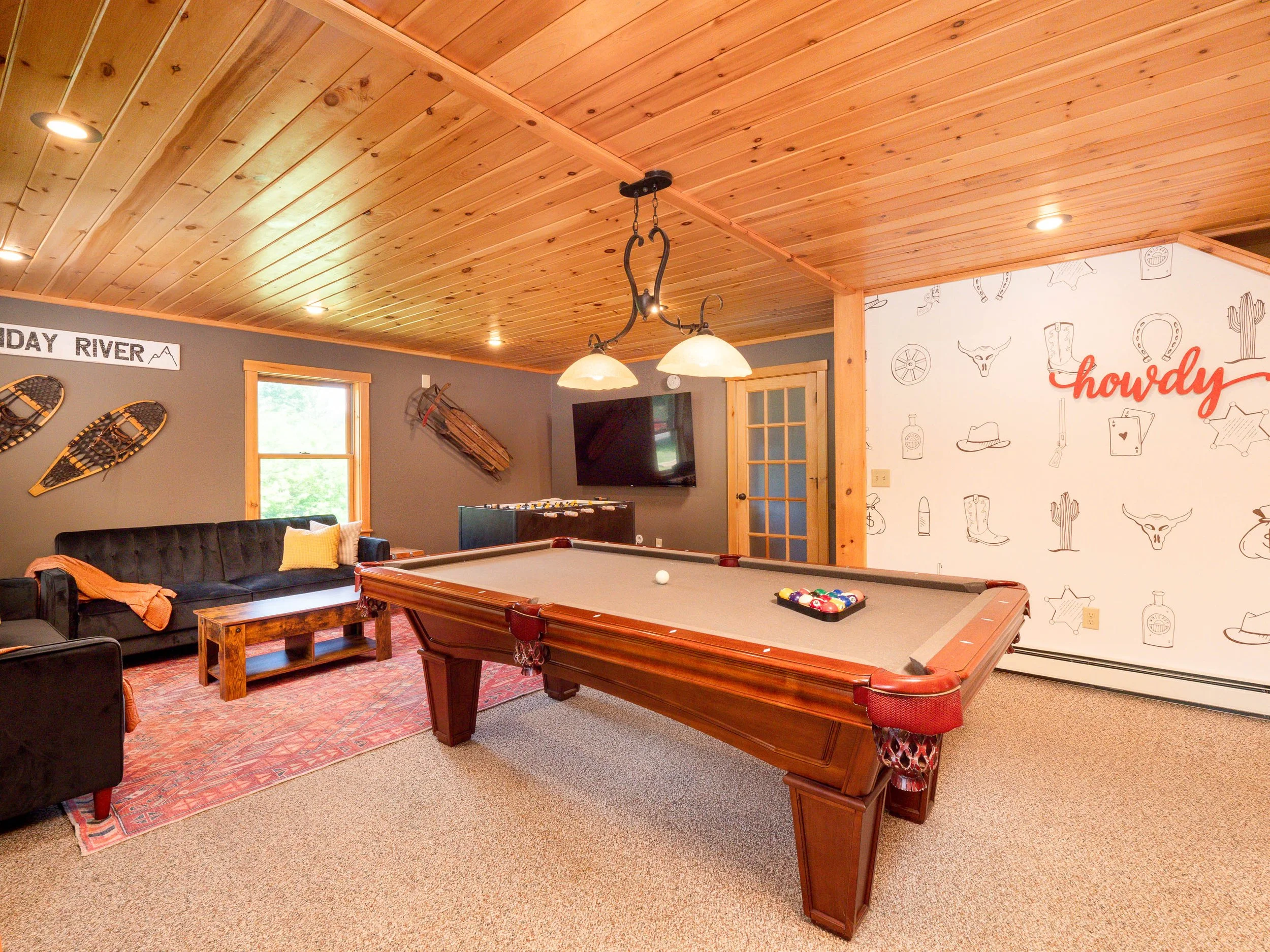 Entertaining game room at The Lone Star at Sunday River vacation rental in Newry Maine for a Maine mountain summer getaway for family fun with pool table and foosball table