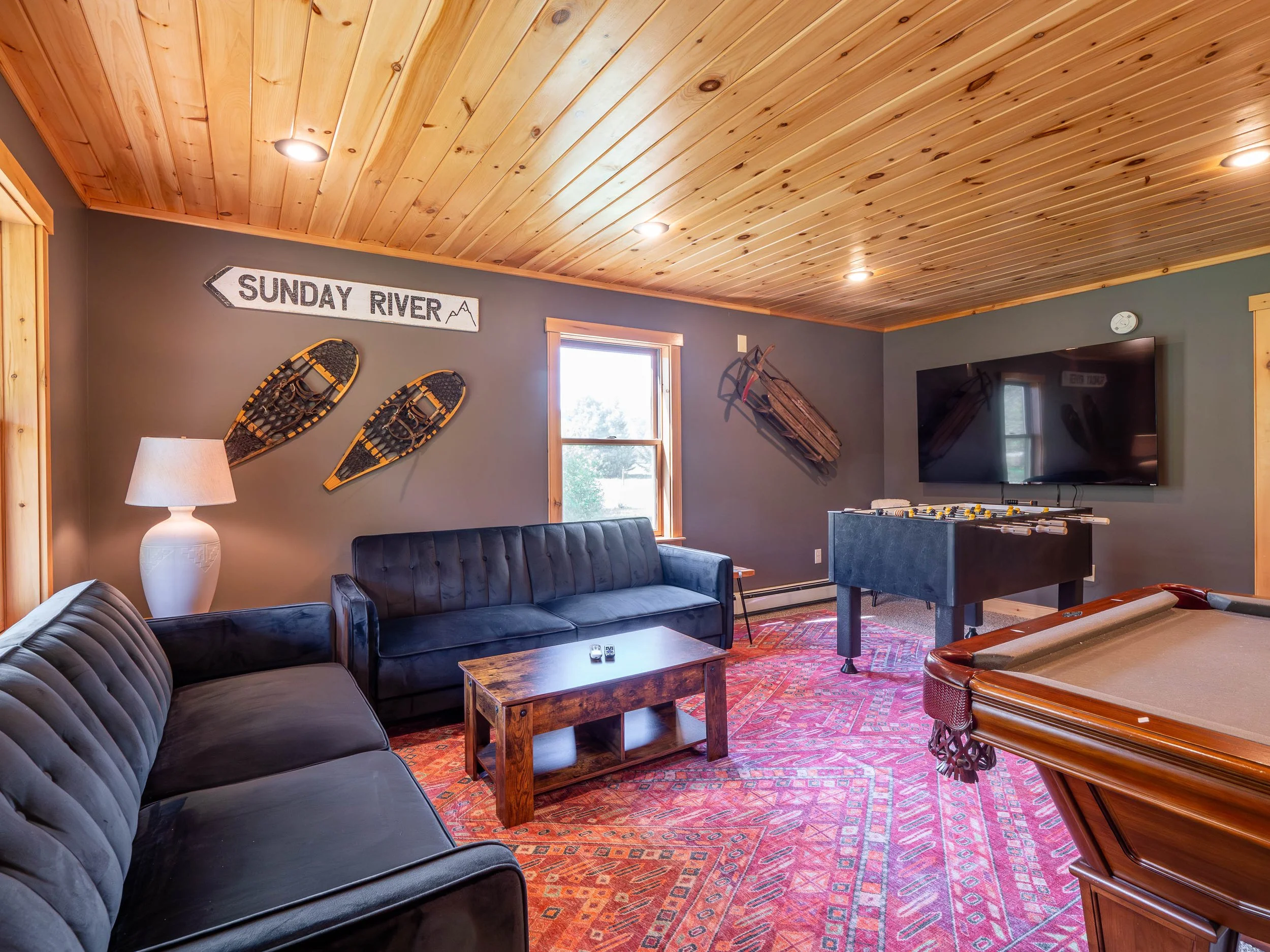 Family-friendly game room at The Lone Star at Sunday River vacation rental in Sunday River area for a Western Maine ski getaway for family fun with foosball table