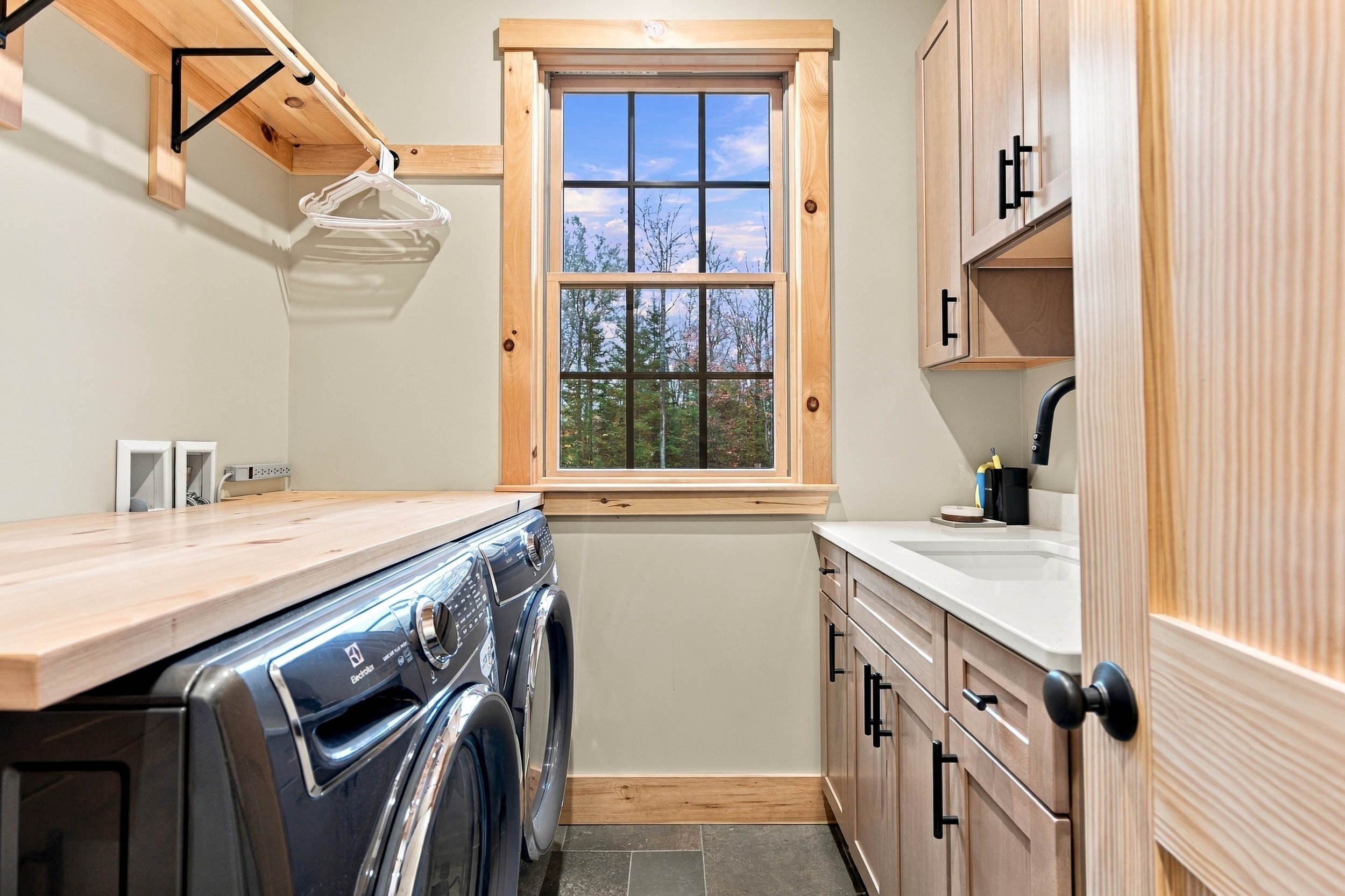 A dedicated laundry room with a full-size washer and dryer, sink, and hangers makes extended stays and family getaways even easier.