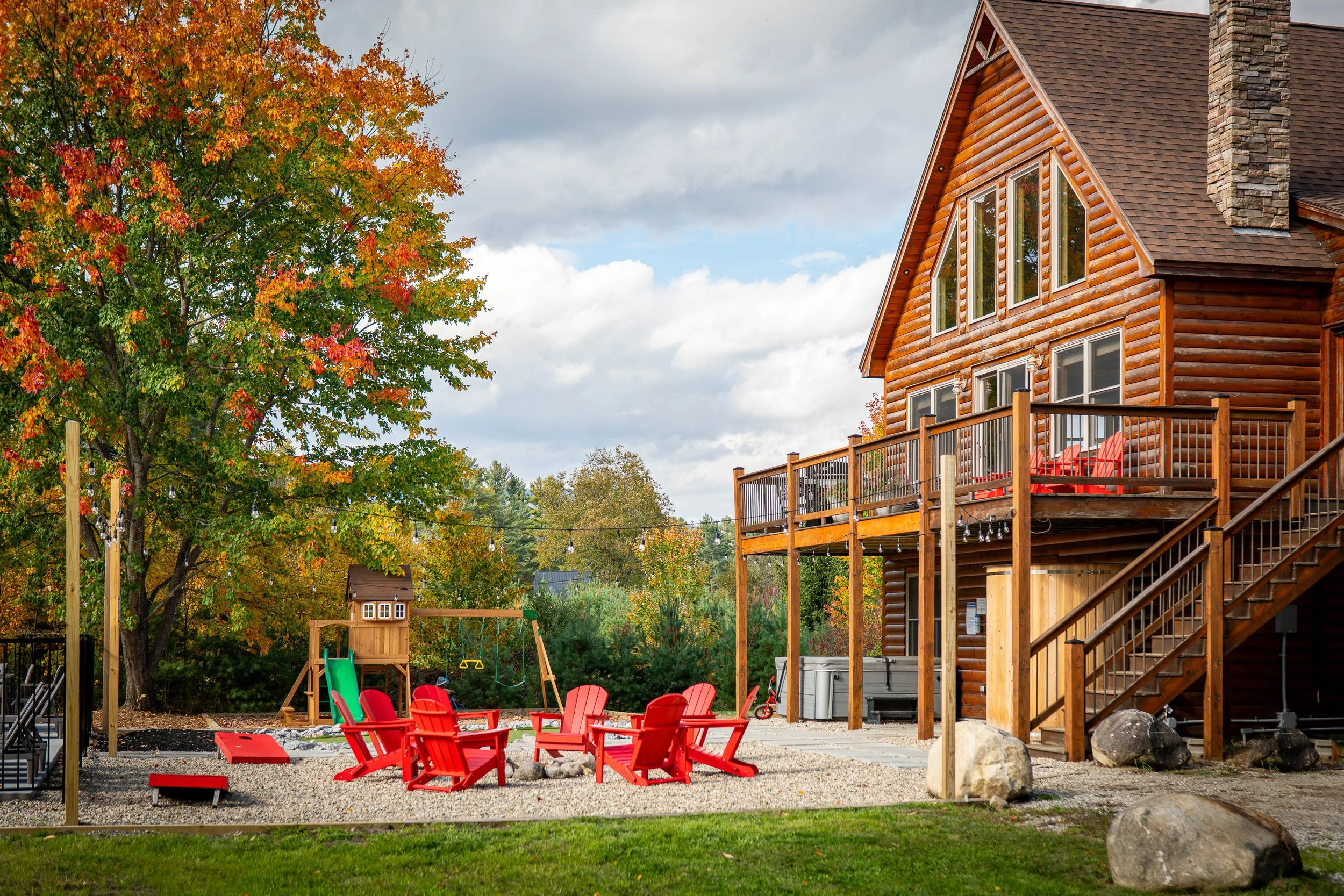 Family-friendly yard with children's play area, children's balance bikes, and sandbox at The Lone Star at Sunday River chalet in Sunday River area.