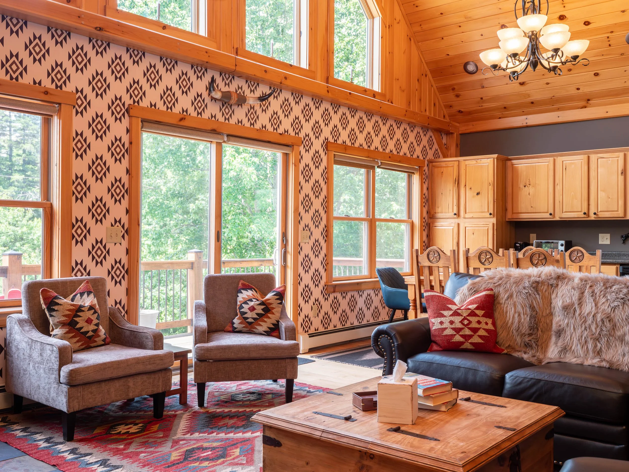 Sun-filled living room at The Lone Star at Sunday River ski house in near Sunday River ski slopes for a Maine mountain winter getaway with large windows