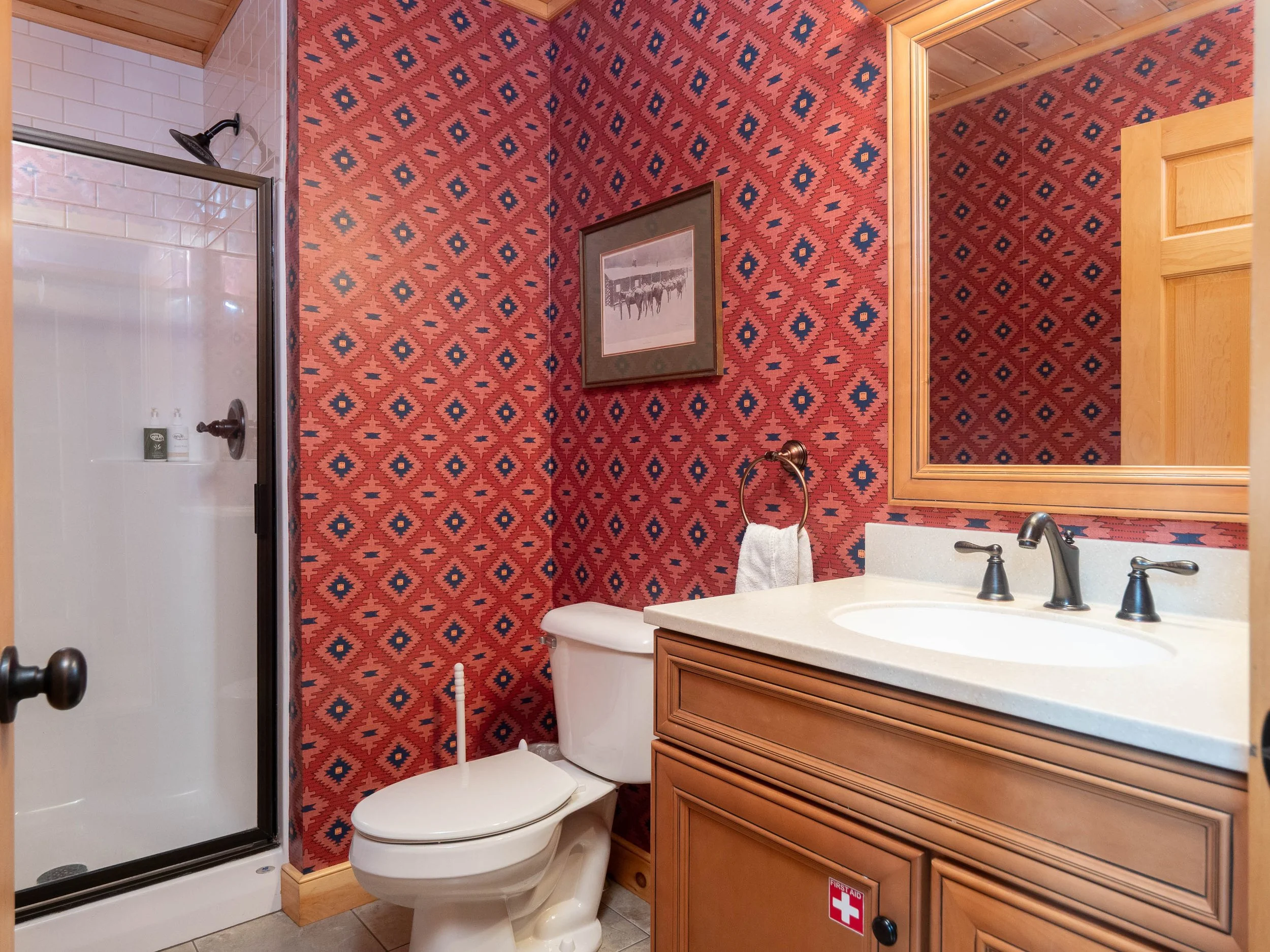 Comfortable main floor full bathroom at The Lone Star at Sunday River chalet in Newry Maine for a fall weekend in Western Maine with walk-in shower
