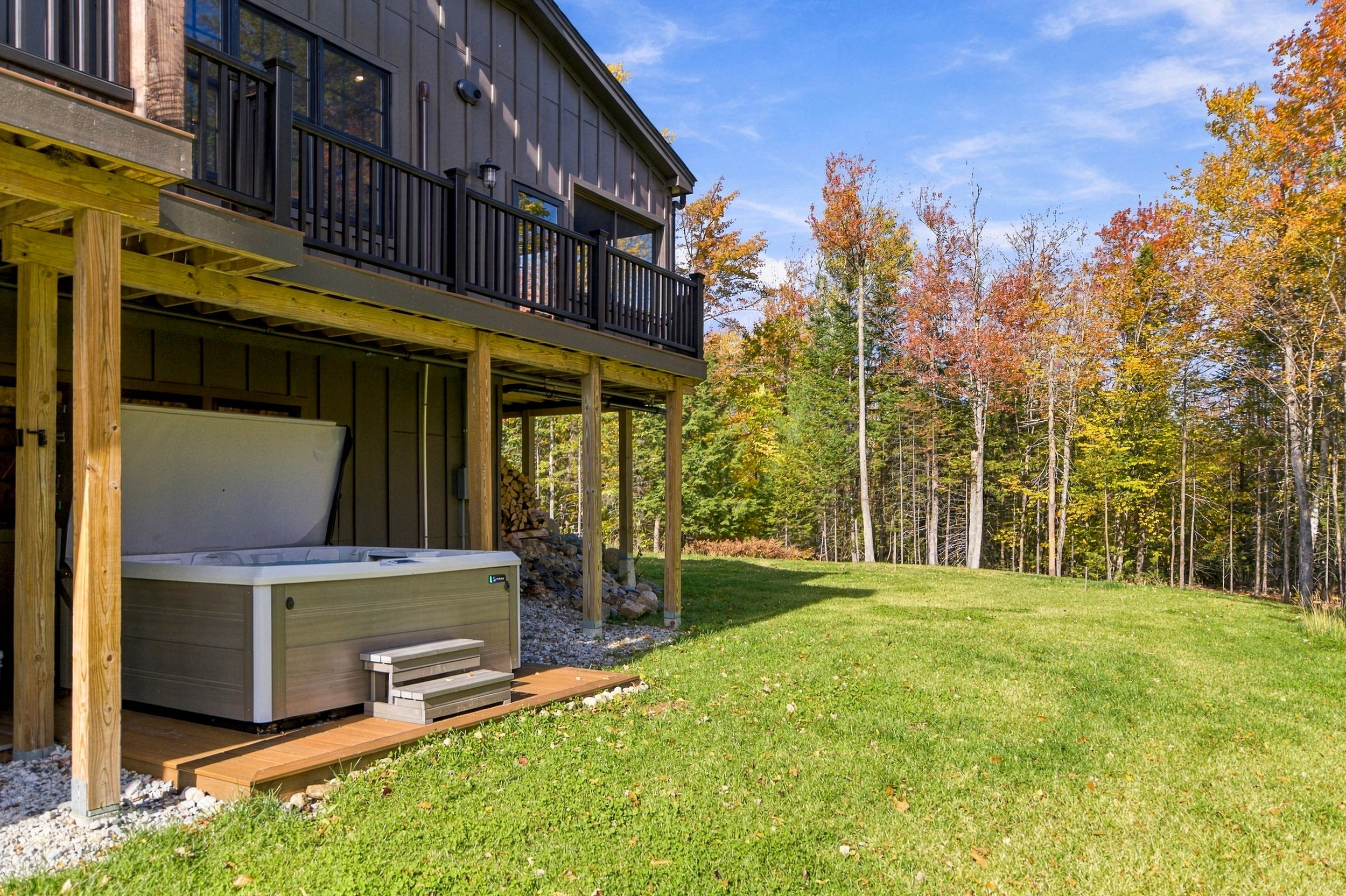 Enjoy the spacious 7-person hot tub surrounded by peaceful woodland scenery.