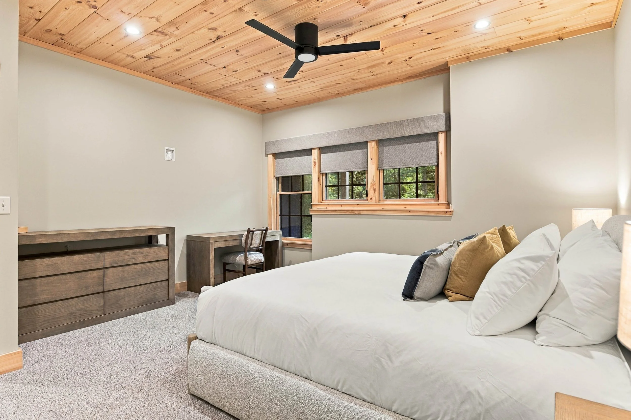 Unwind in this comfortable lower-level king bedroom, offering a peaceful retreat and dedicated workspace.