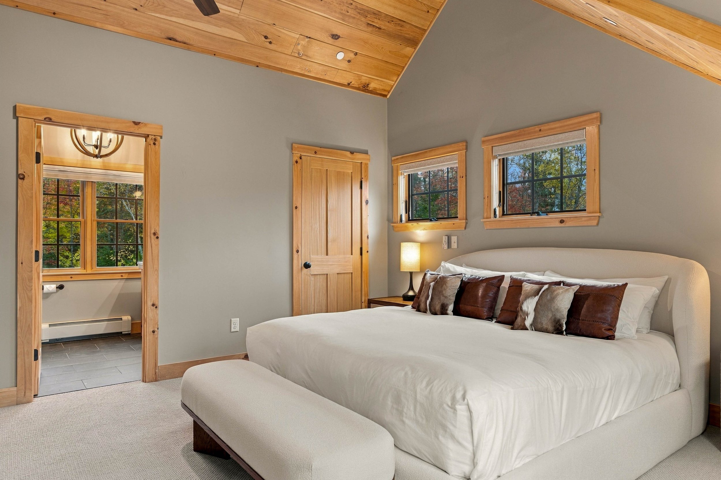 Thoughtful furnishings, soft bedding, and natural wood accents create a restful mountain escape.
