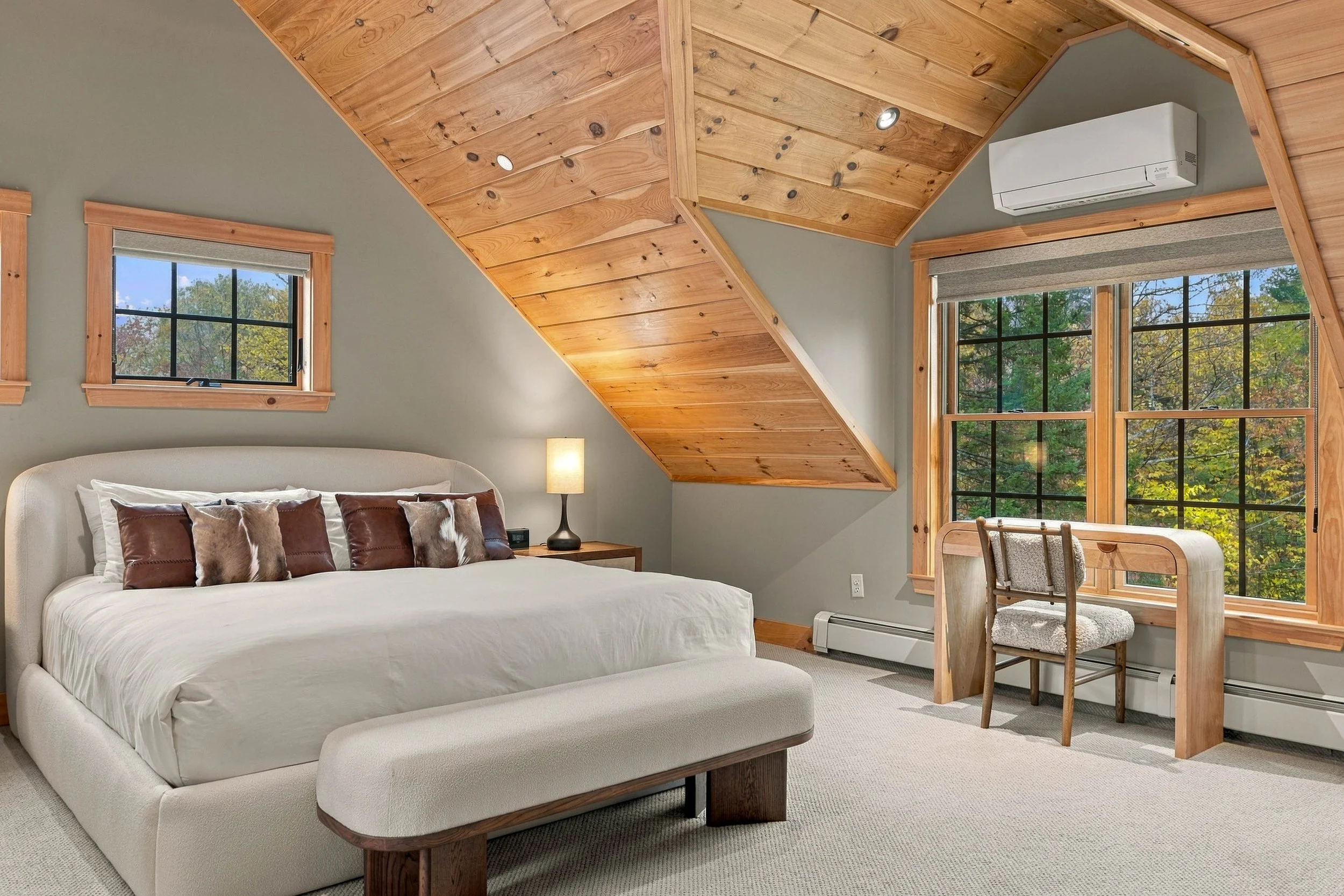 Retreat to this inviting upper-level dual primary king suite with vaulted ceilings, a private ensuite bathroom, and a dedicated workspace.