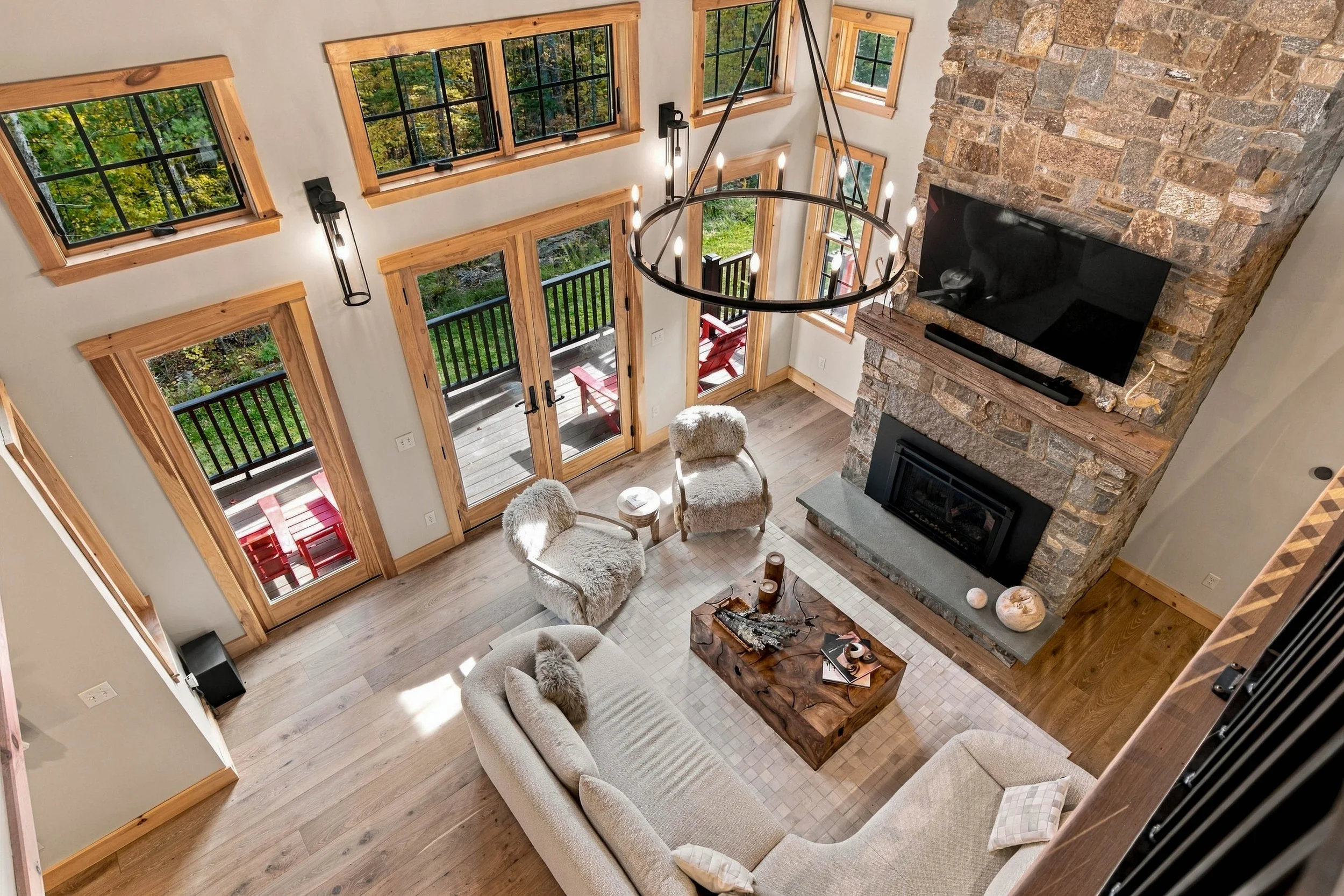 A bird's-eye view of the stunning great room, where soaring ceilings and a dramatic stone fireplace steal the show.