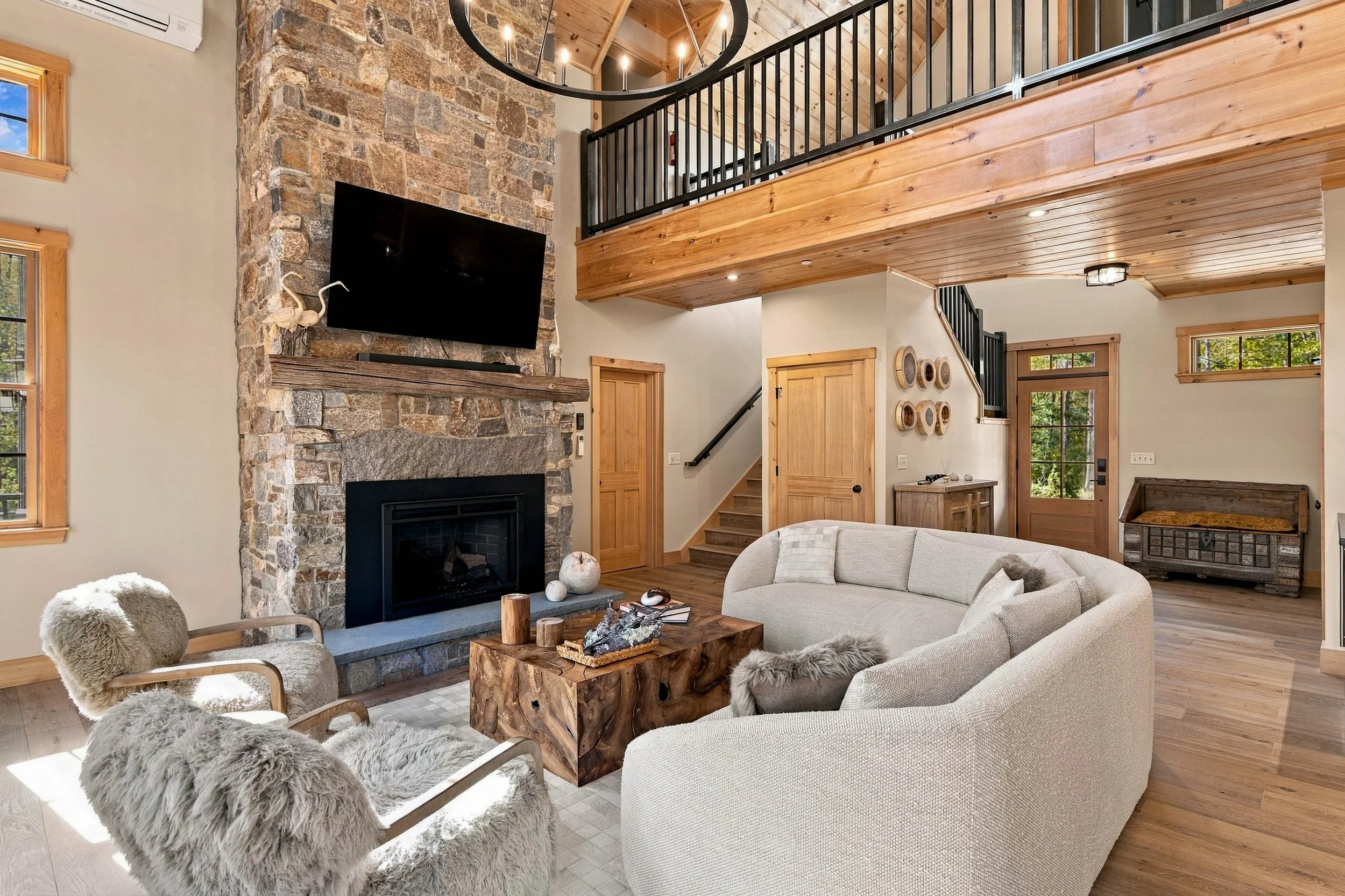 Relax beside the grand stone gas fireplace, with soaring windows that bring the beauty of the Maine woods indoors.