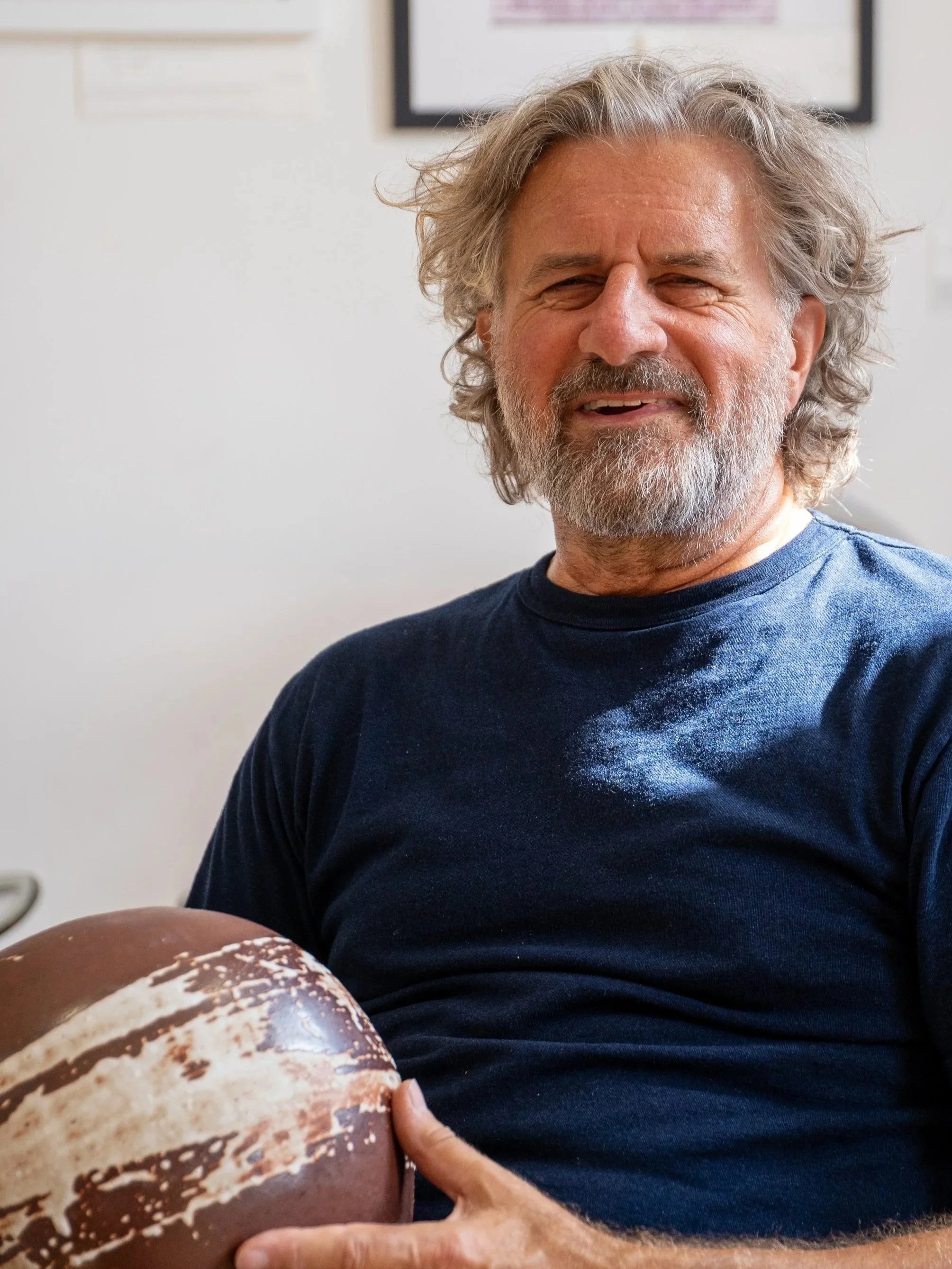 The artist holding a piece from his Enso collection.